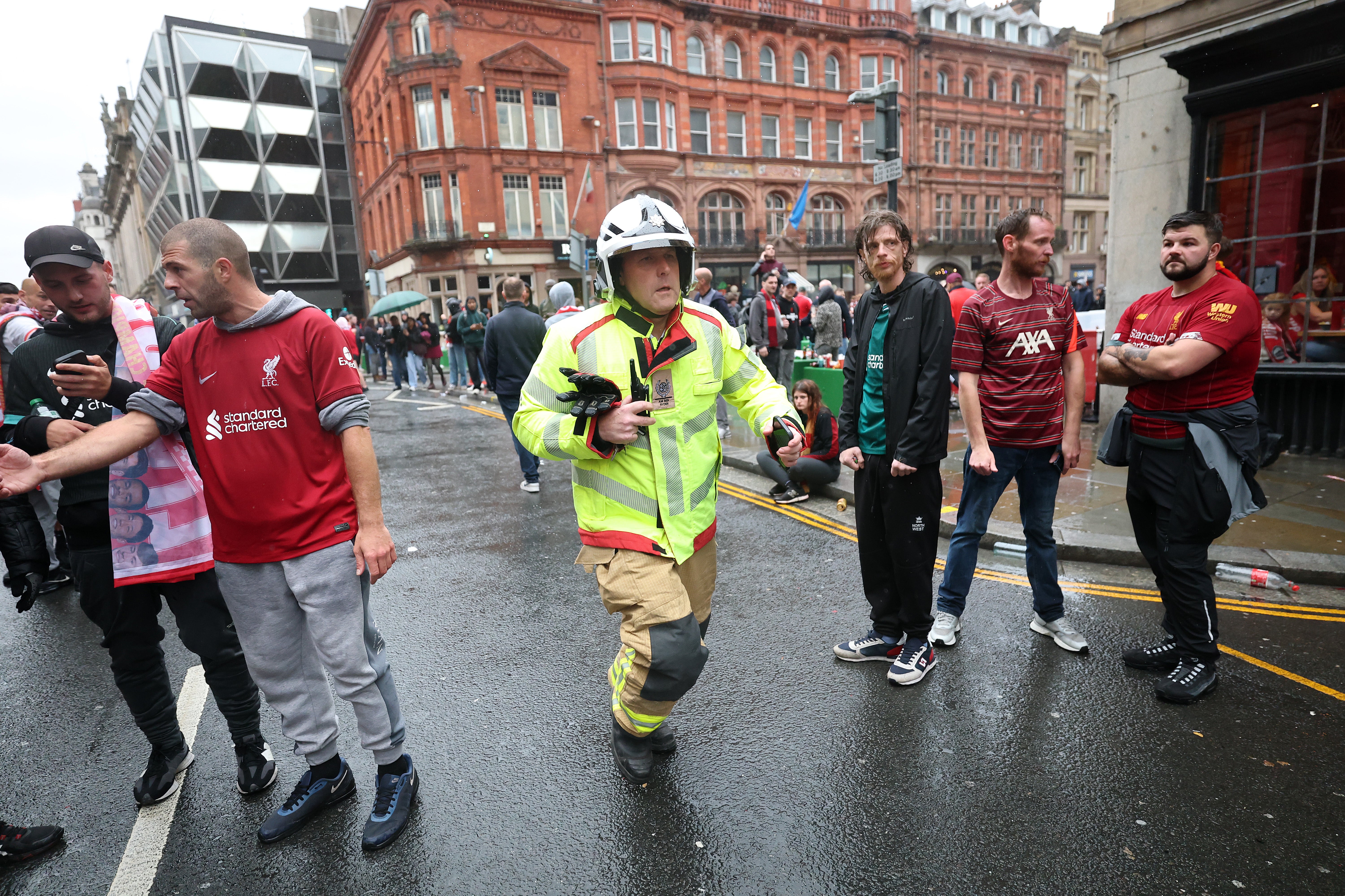 Ben Ryder, area manager at Merseyside Fire and Rescue Service runs toward the scene of the crash in Water Street in Liverpool