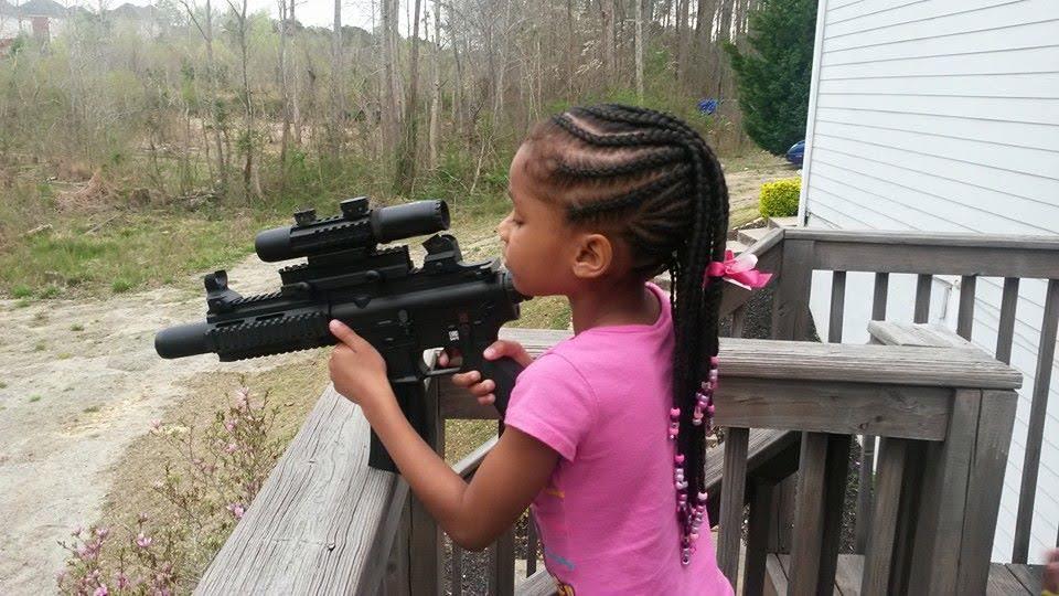 Kennedy Thrasher, age 5, holding the same gun as Naomi above
