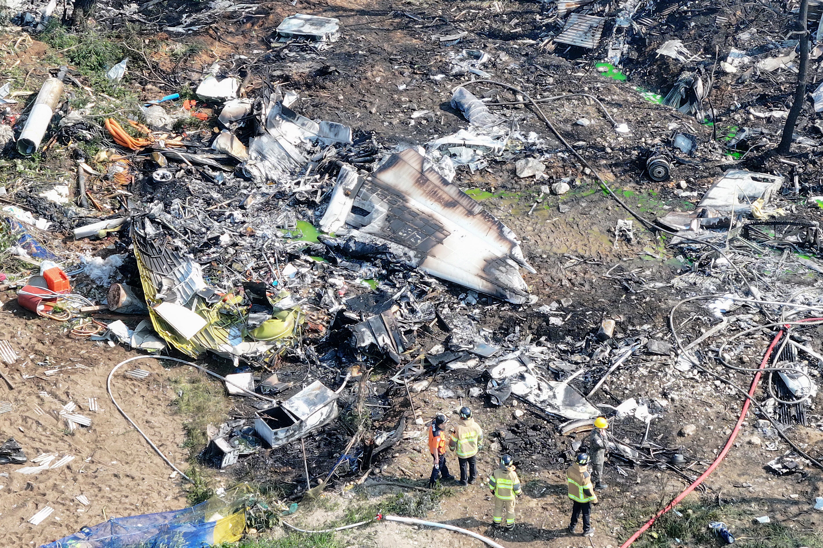 Pictures show charred debris of the navy plane that crash on 29 May