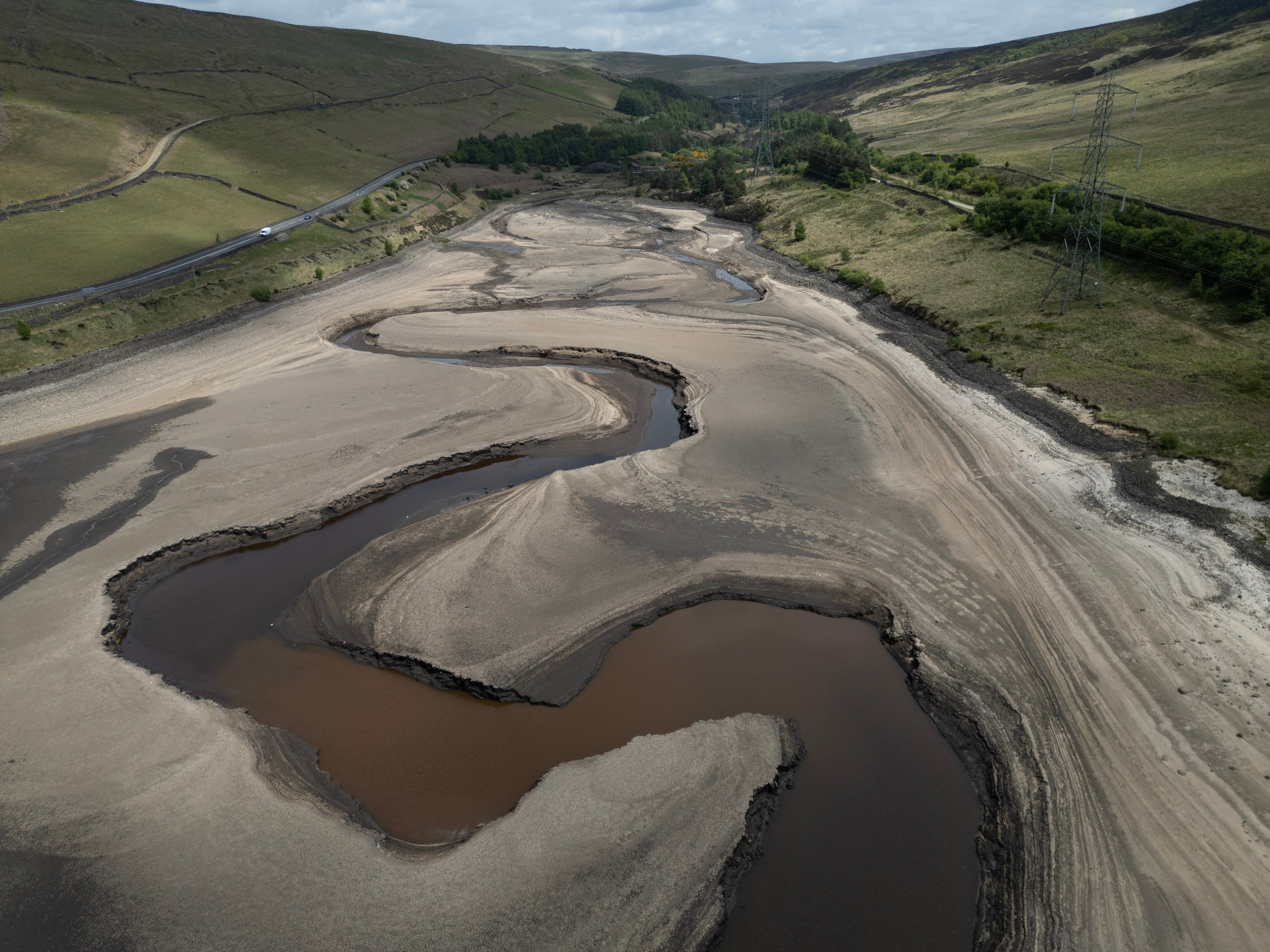 An aerial photo from 22 May shows the bed of Woodhead Reservoir is partially revealed by a falling water level, near Glossop