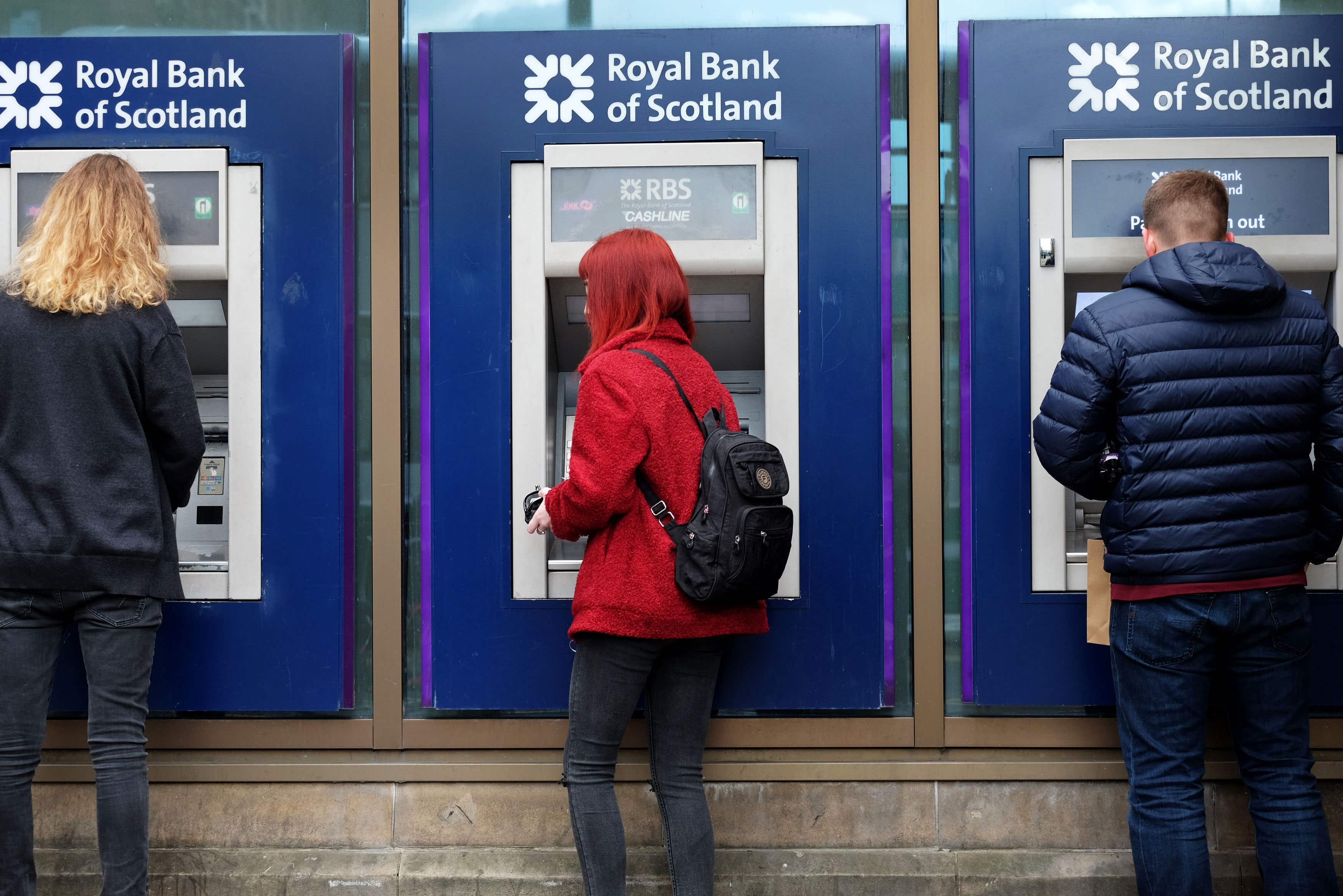 Members of the public use Royal Bank of Scotland cash machines (Jane Barlow/PA Wire).