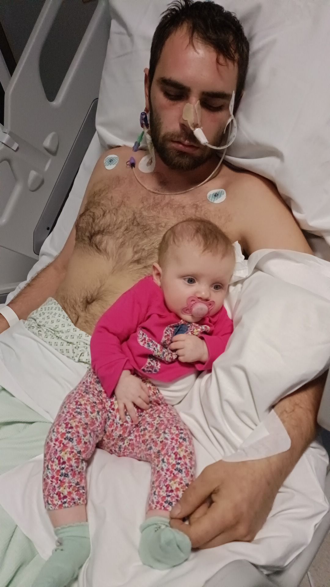 Daughter Ivy, then three months old, visits her dad in hospital