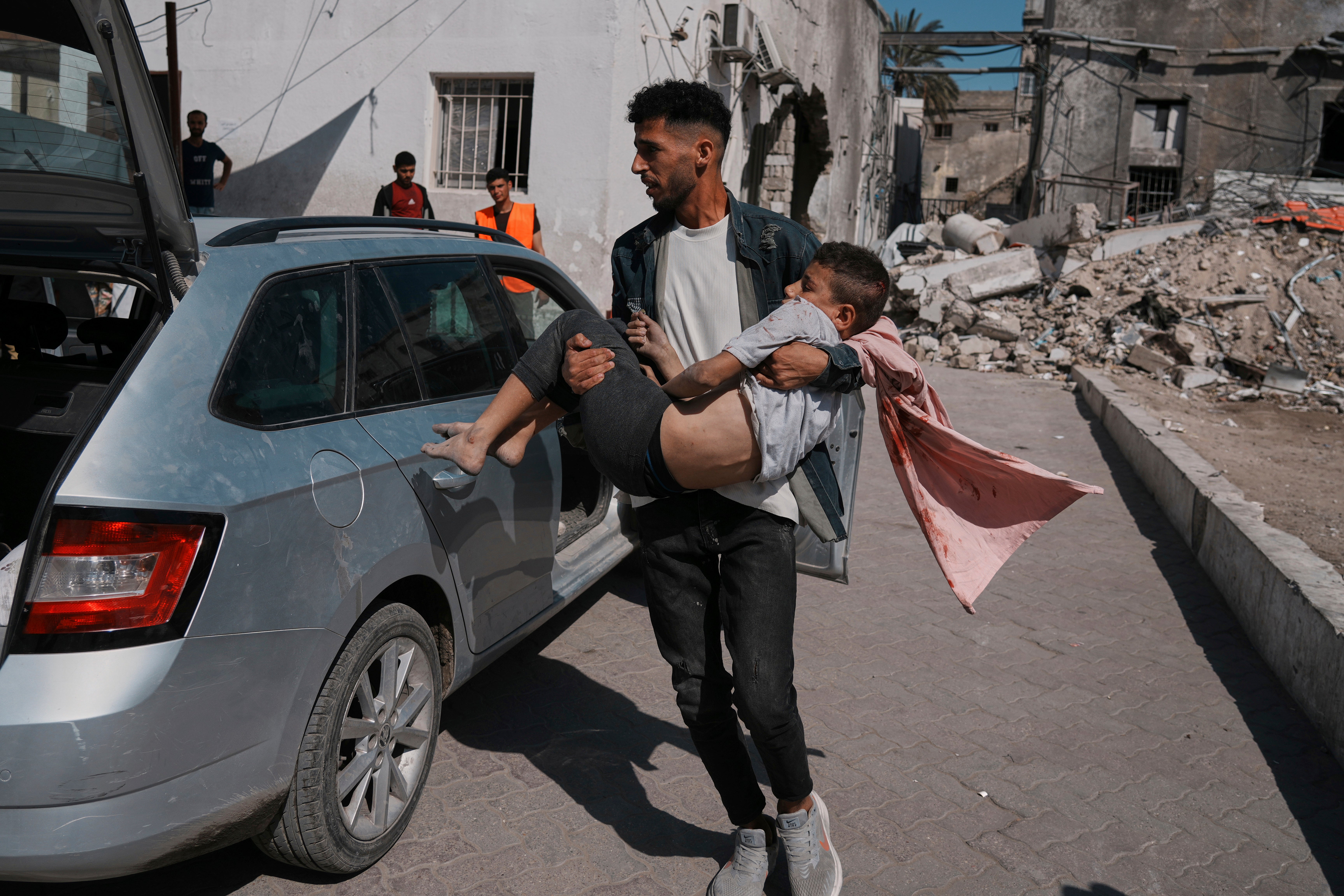 A Palestinian boy, injured following an Israeli airstrike, is brought for treatment to the Baptist Hospital in Gaza City