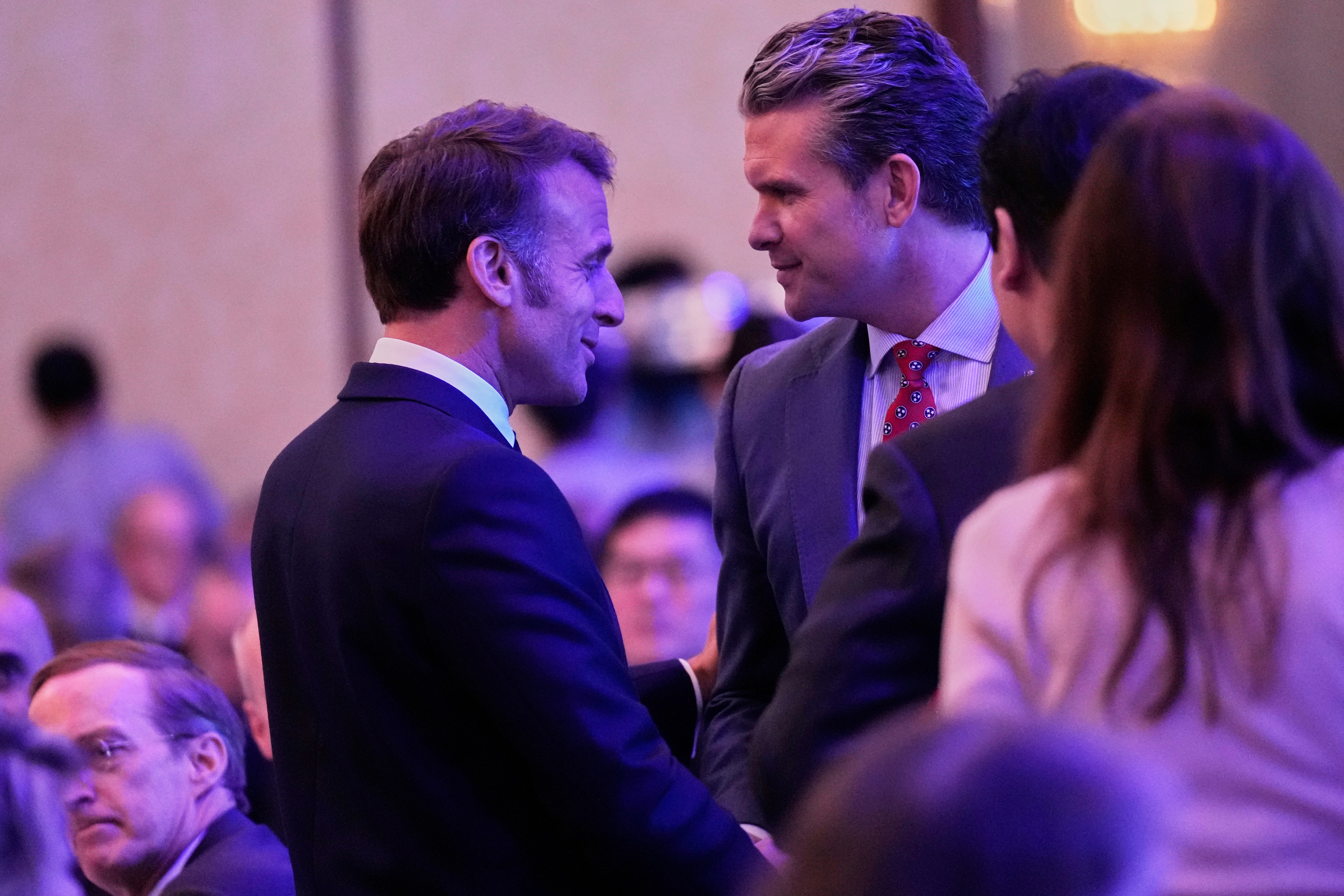 French President Emmanuel Macron, left, and US Defence secretary Pete Hegseth talk during the 22nd Shangri-La Dialogue summit in Singapore
