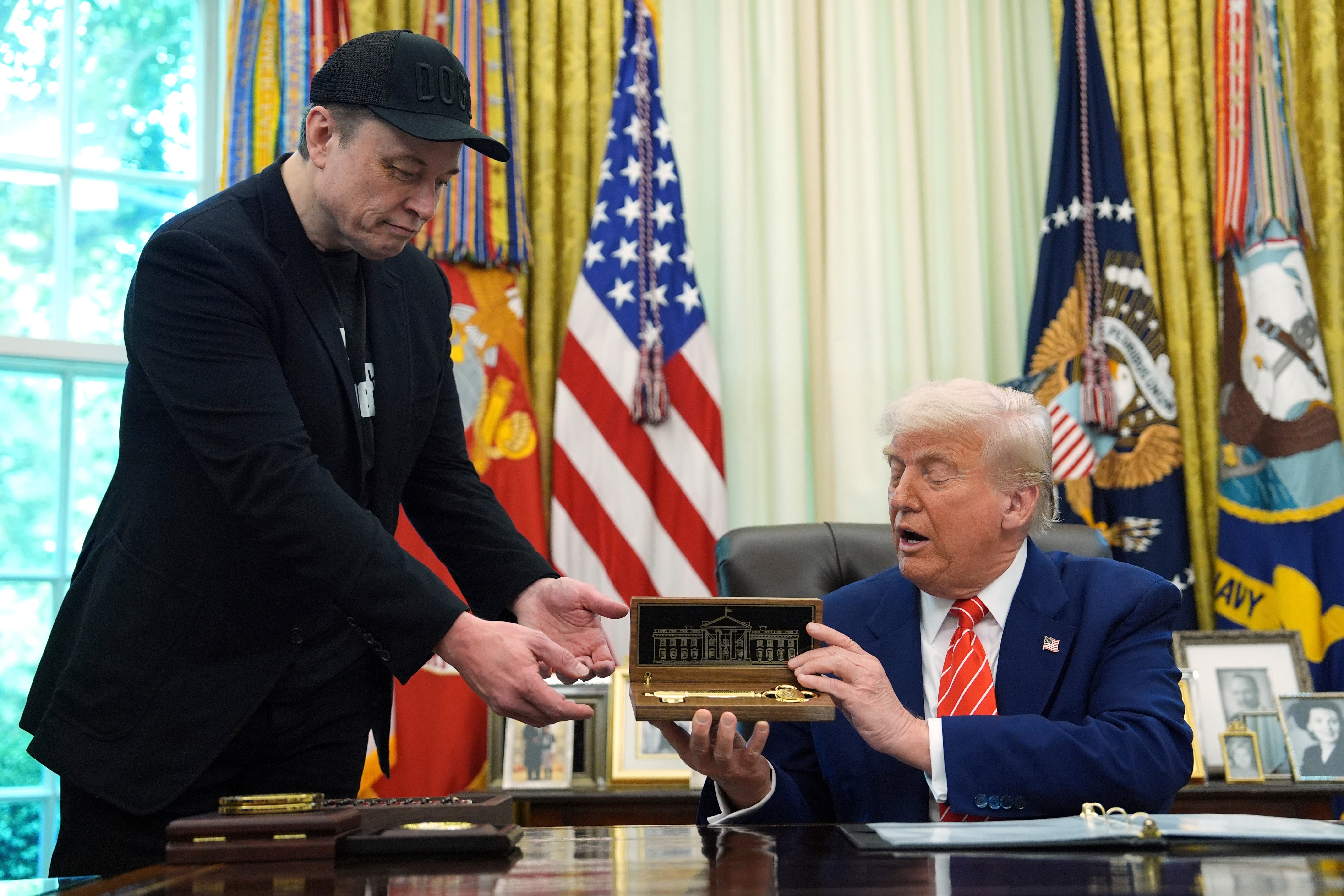 Trump, right, presented a key to Elon Musk as a token of appreciation during the Oval Office news conference on Friday