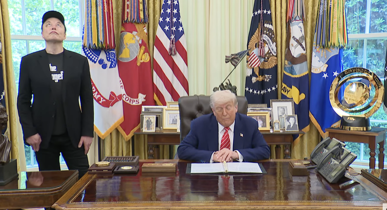 Elon Musk looks up to the sky as President Donald Trump talks about Musk’s achievements as a special government employee