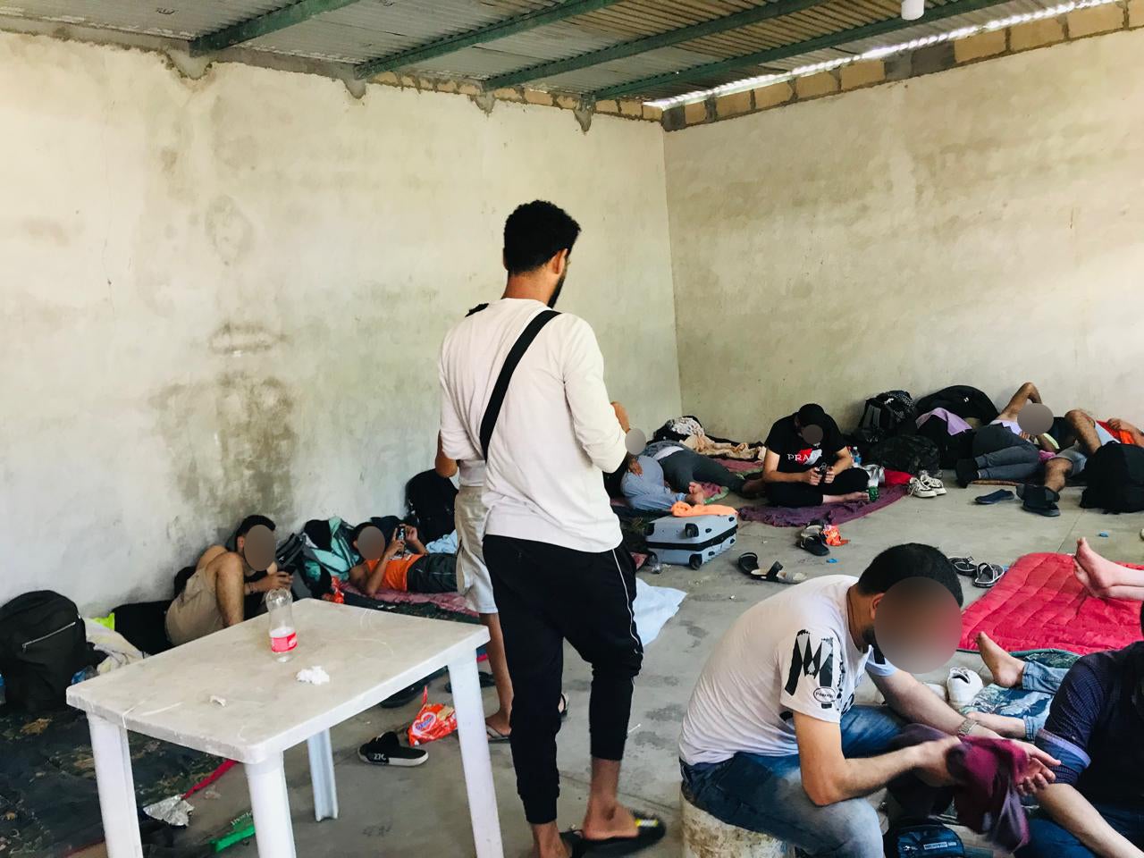 A group of migrants, among them Egyptians, wait in a Mexican camp to continue their journey to the border