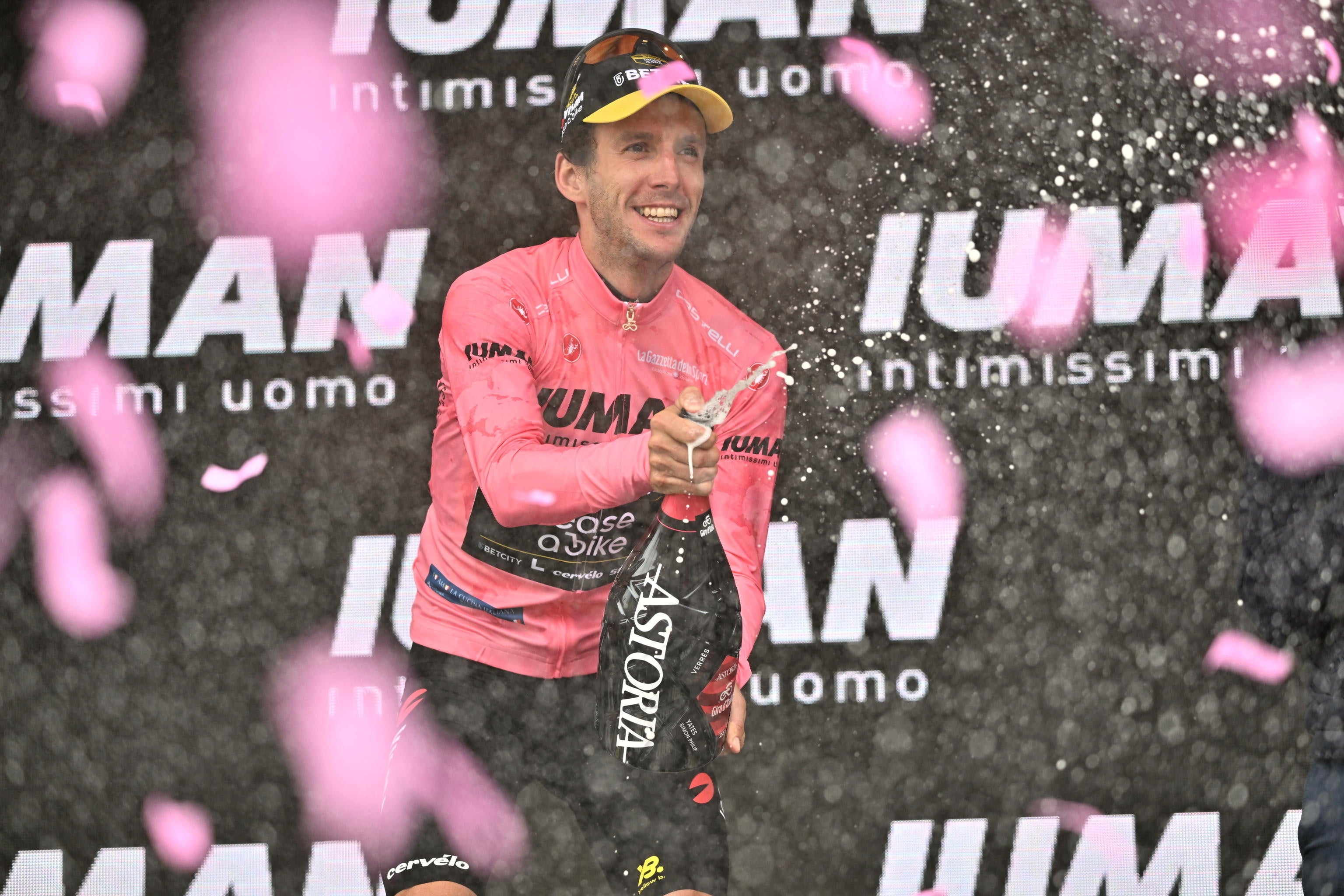 Yates celebrates on the podium after his stage 20 triumph