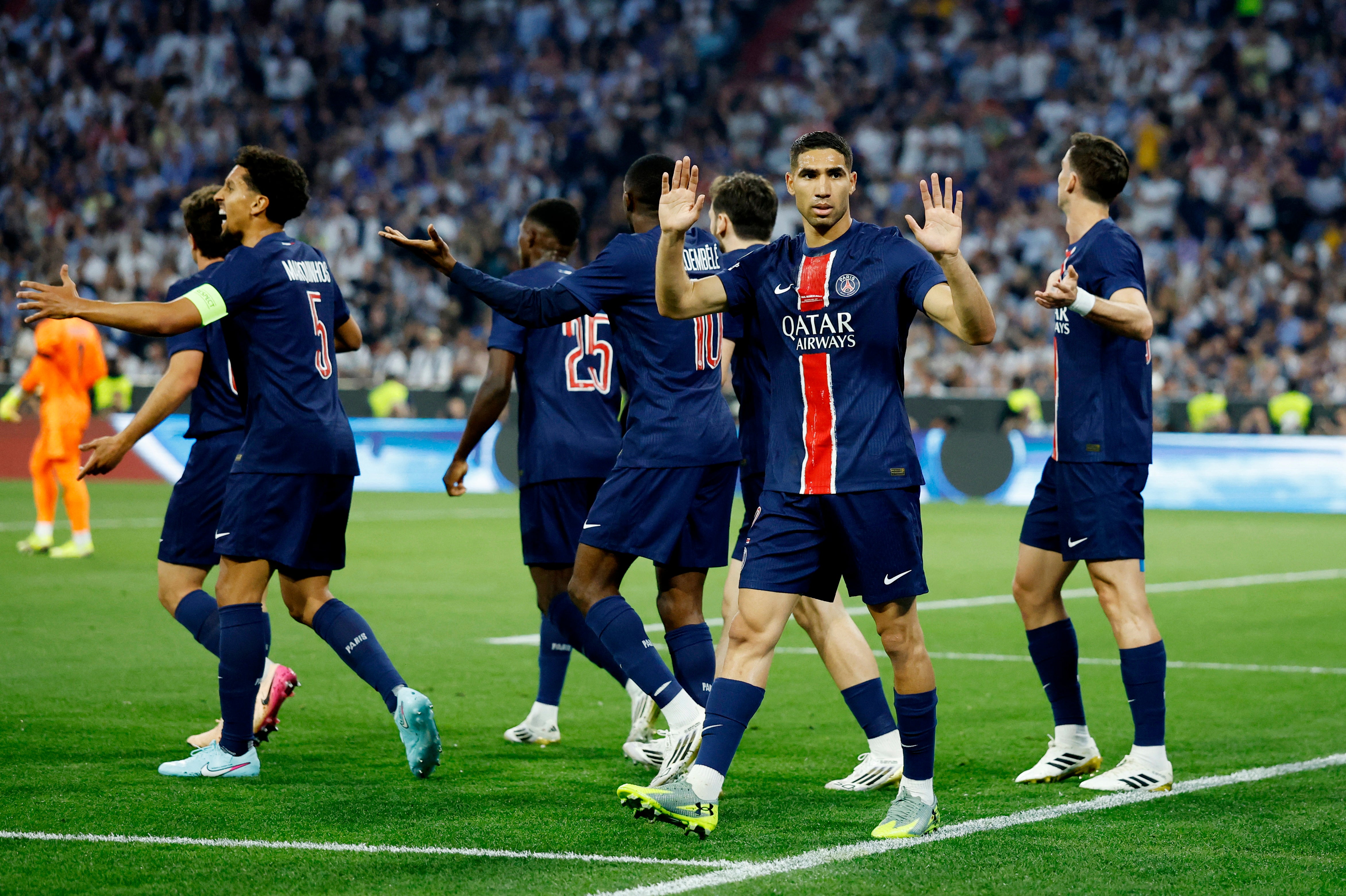 PSG's Achraf Hakimi holds up his hands to the Inter fans