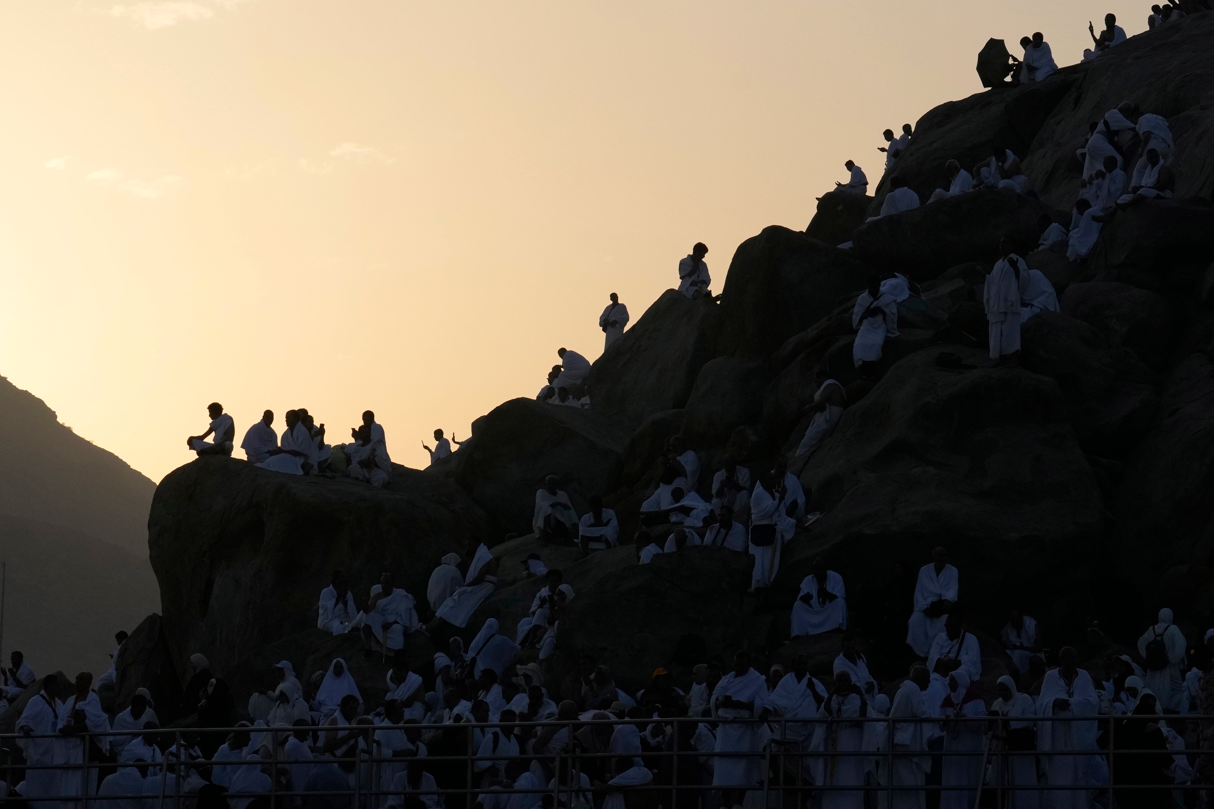 Muslim pilgrims gather at top of the rocky hill known as the Mountain of Mercy, on the Plain of Arafat, during the annual Hajj pilgrimage, near the holy city of Mecca, Saudi Arabia, Saturday, June 15, 2024.(AP Photo/Rafiq Maqbool, File)