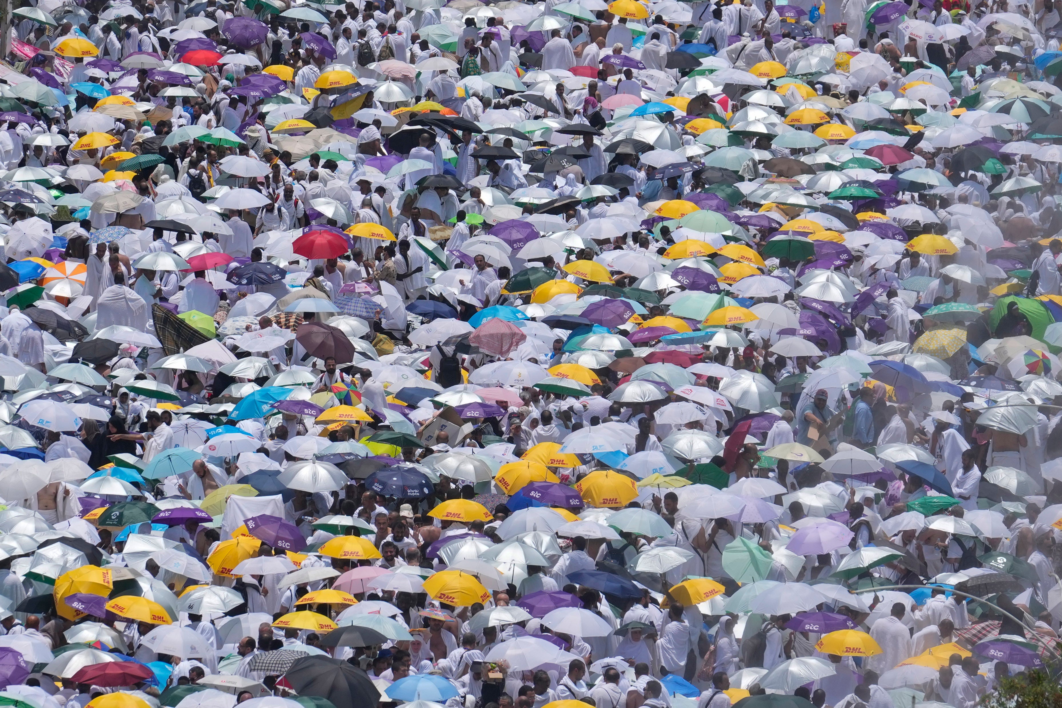 Muslim pilgrims use umbrellas to shield themselves from the sun as they gather outside Nimrah Mosque to offer the noon prayers in Arafat, on the second day of the annual hajj pilgrimage, near the holy city of Mecca, Saudi Arabia, Saturday, June 15, 2024. (AP Photo/Rafiq Maqbool, File)