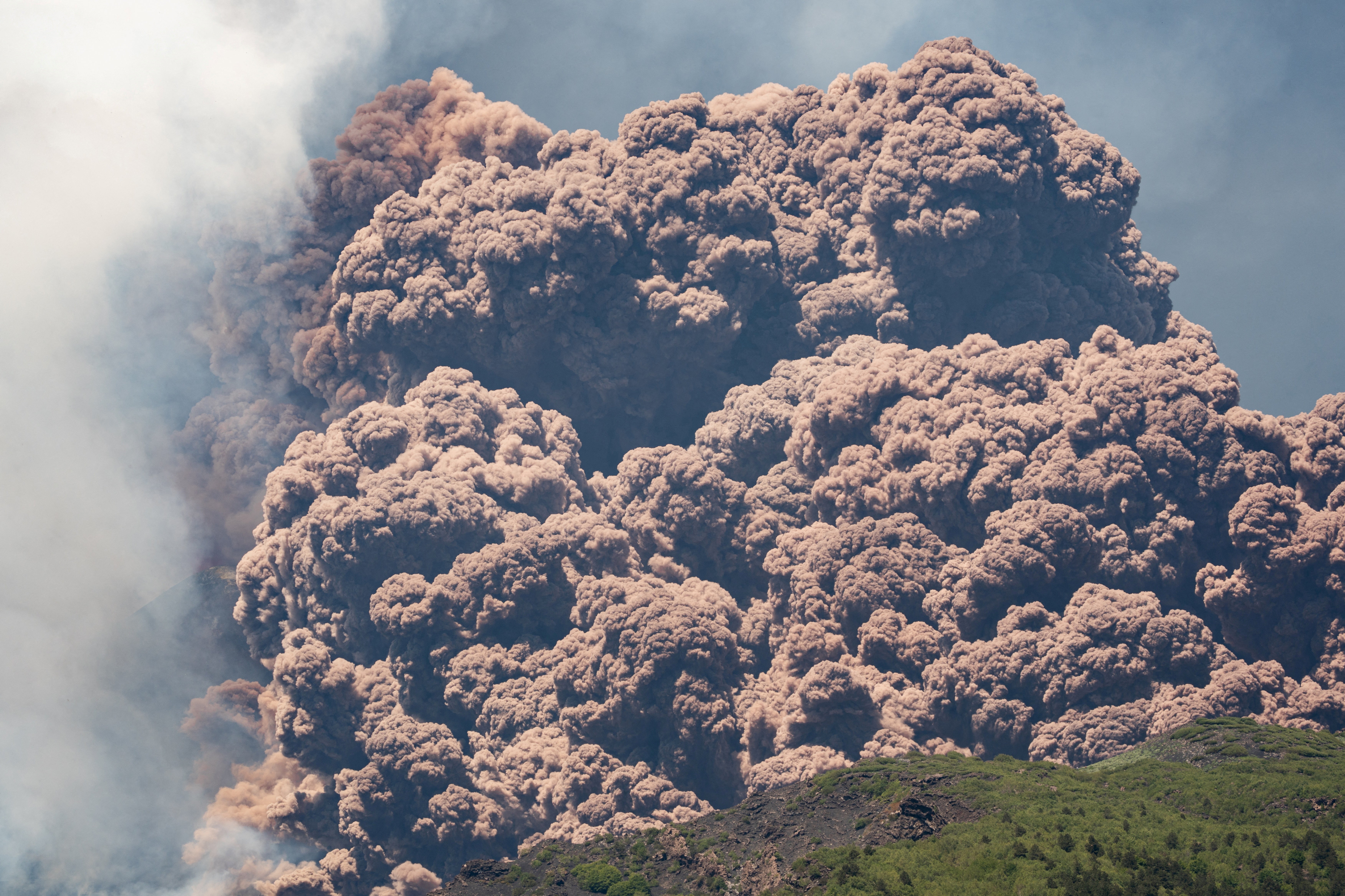Plumes of ash and volcanic steam rise from Mount Etna