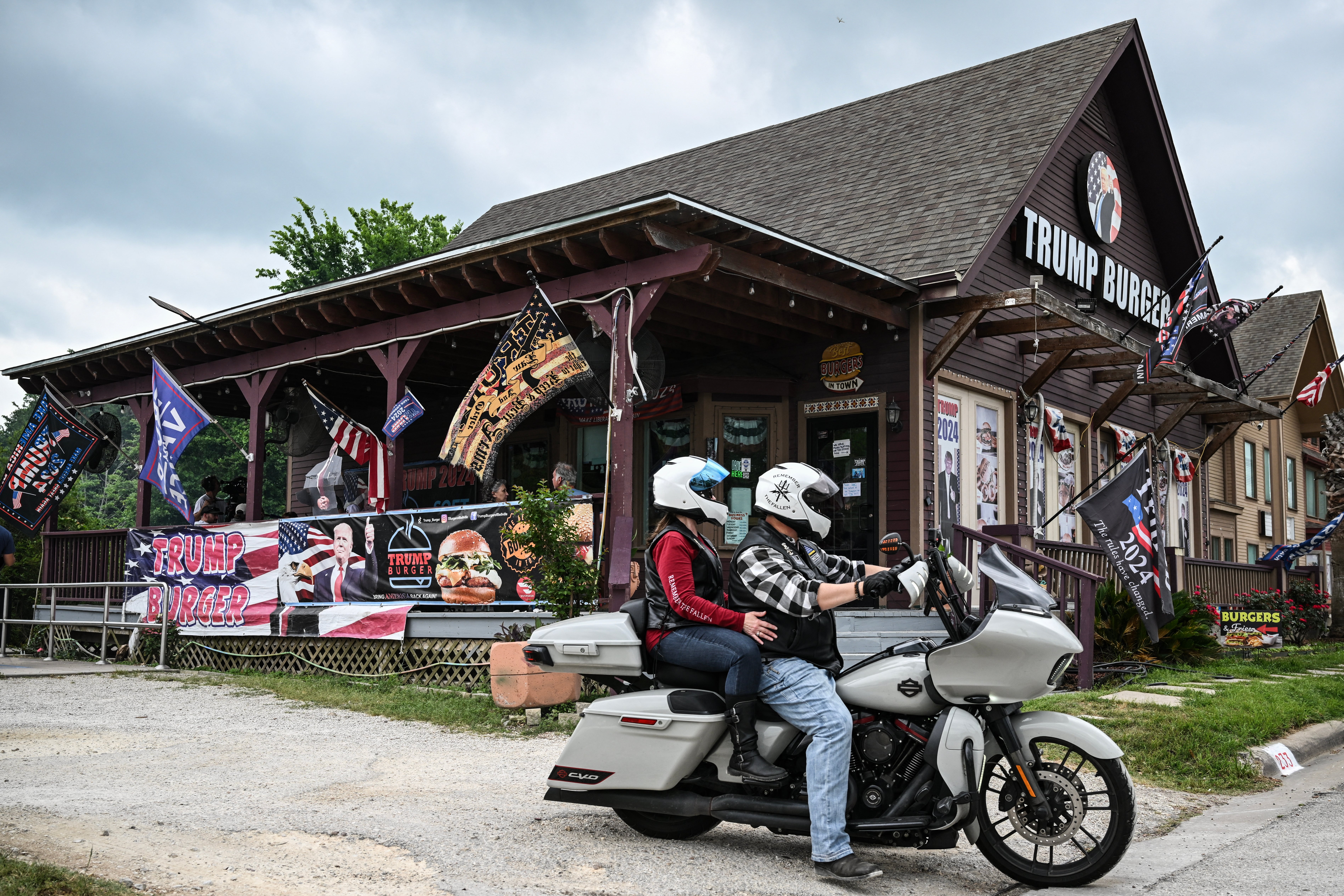 A motorcycle passes in front of a Trump Burger restaurant in Bellville, Texas