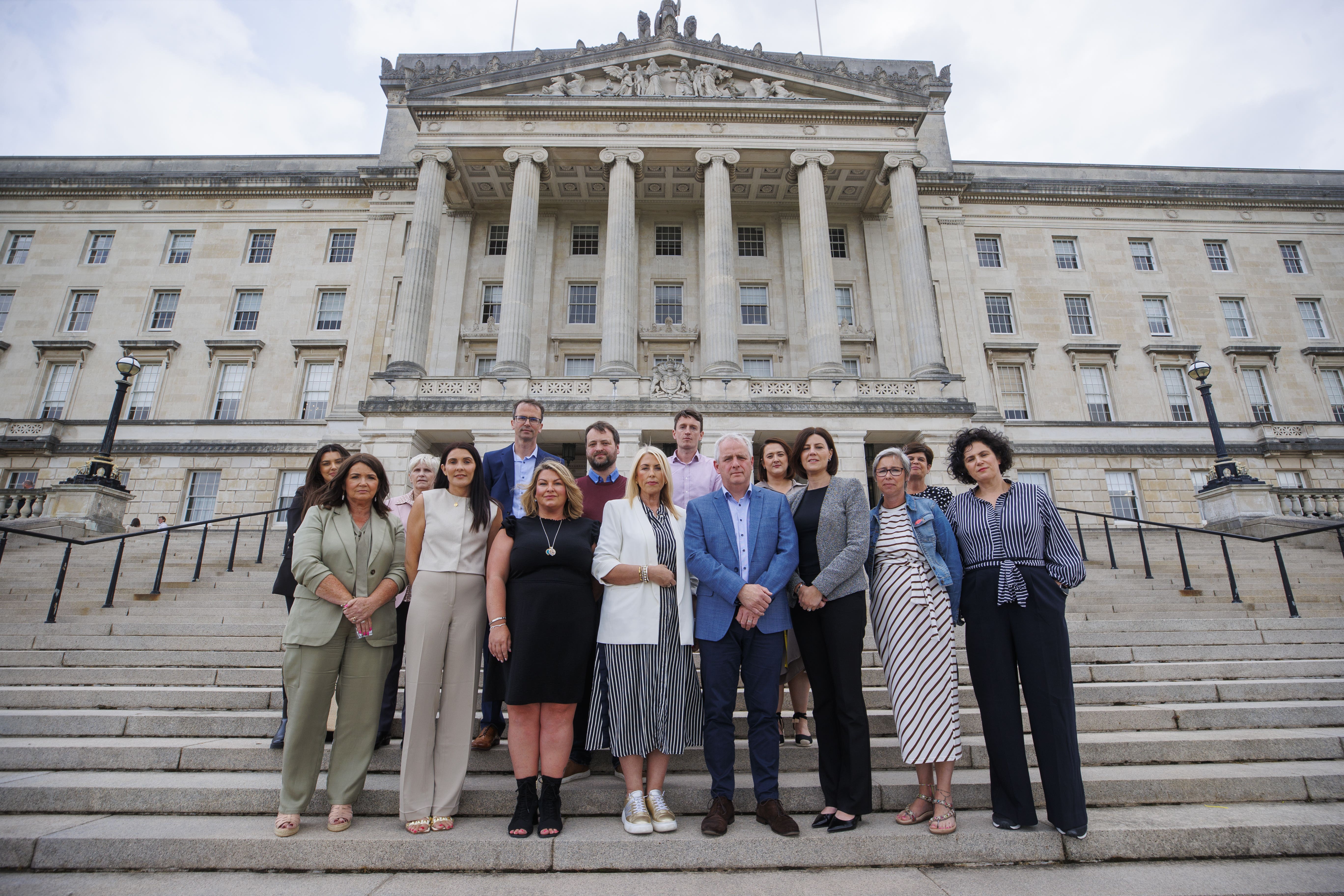 SDLP leader Claire Hanna MP (right) with Stella McMullan (fourth from left), mother of Caitlin-Rose McMullan, Bob Hogg (sixth from right) father of Caitlin Hogg, Amelia O’Neill (third from right) mother of Fintan and Mary O’Neill, with Dr Mark Terris (fifth from left), and Dr Damien Gates (seventh from right), and families who have been impacted by crashes at school bus stops in Northern Ireland (Liam McBurney/PA)
