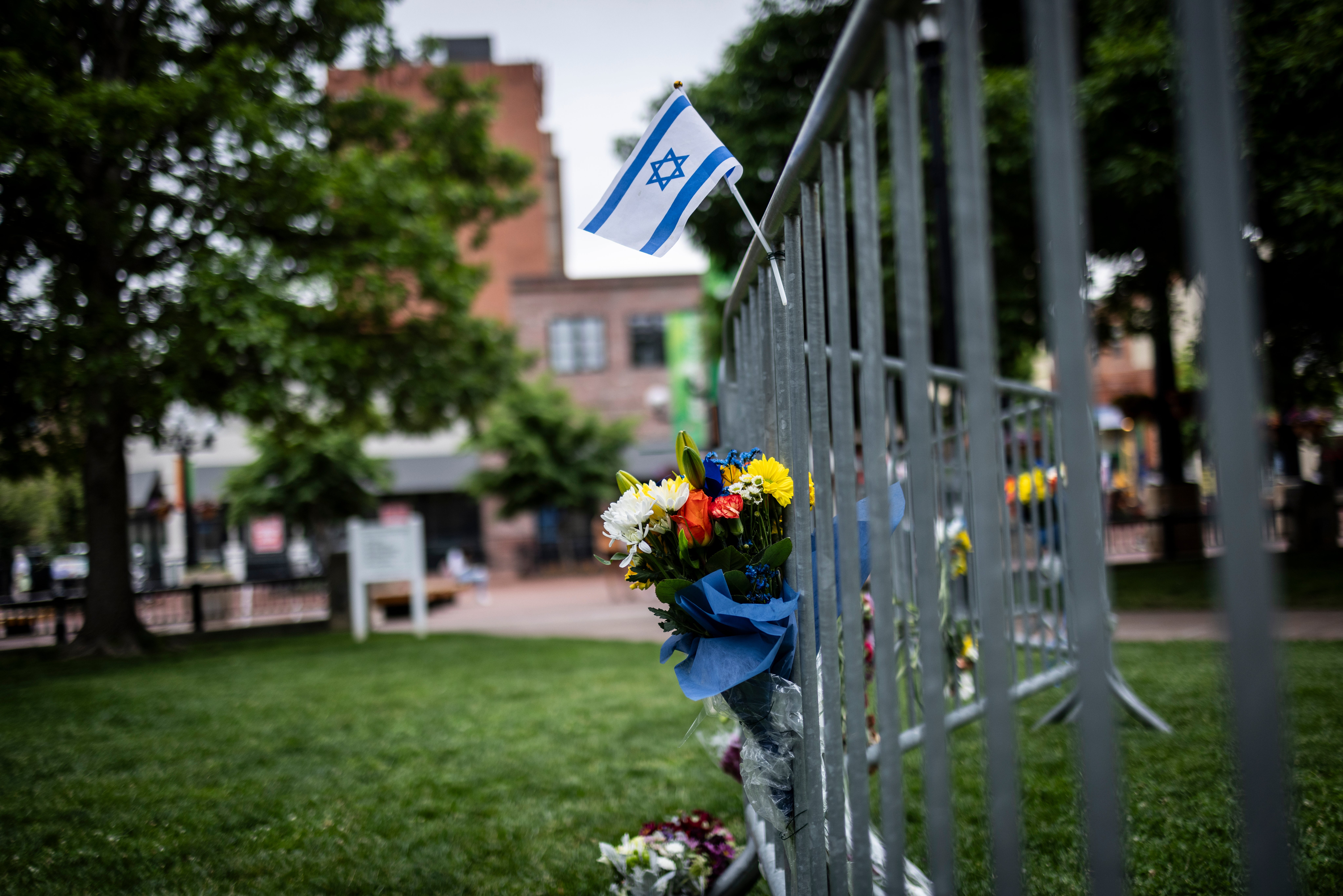 Flowers and a flag outside the Boulder County Courthouse