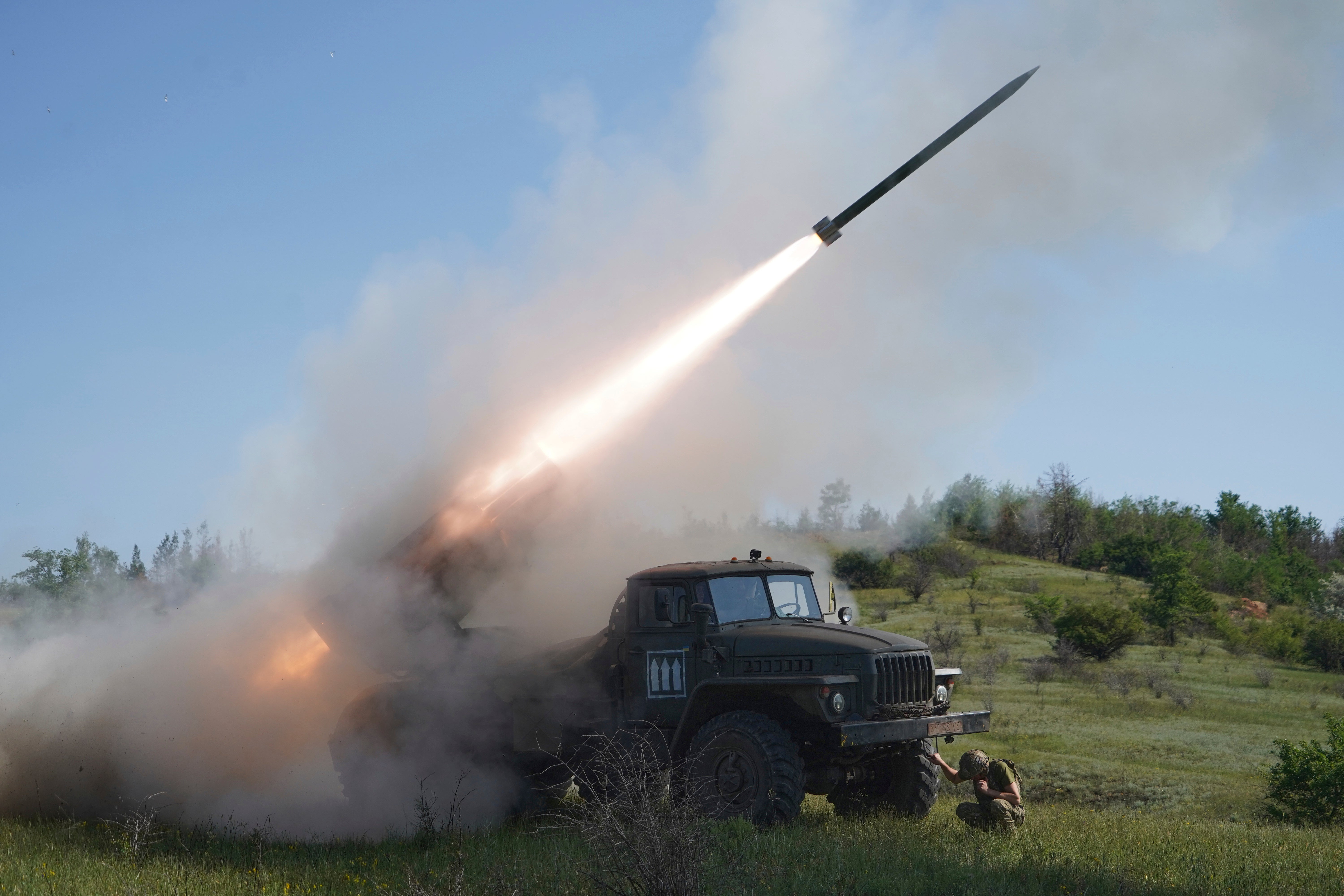 Soldiers of Ukraine's 30th Separate Mechanised Brigade fire a Grad multiple rocket launcher towards Russian positions in the Donetsk region
