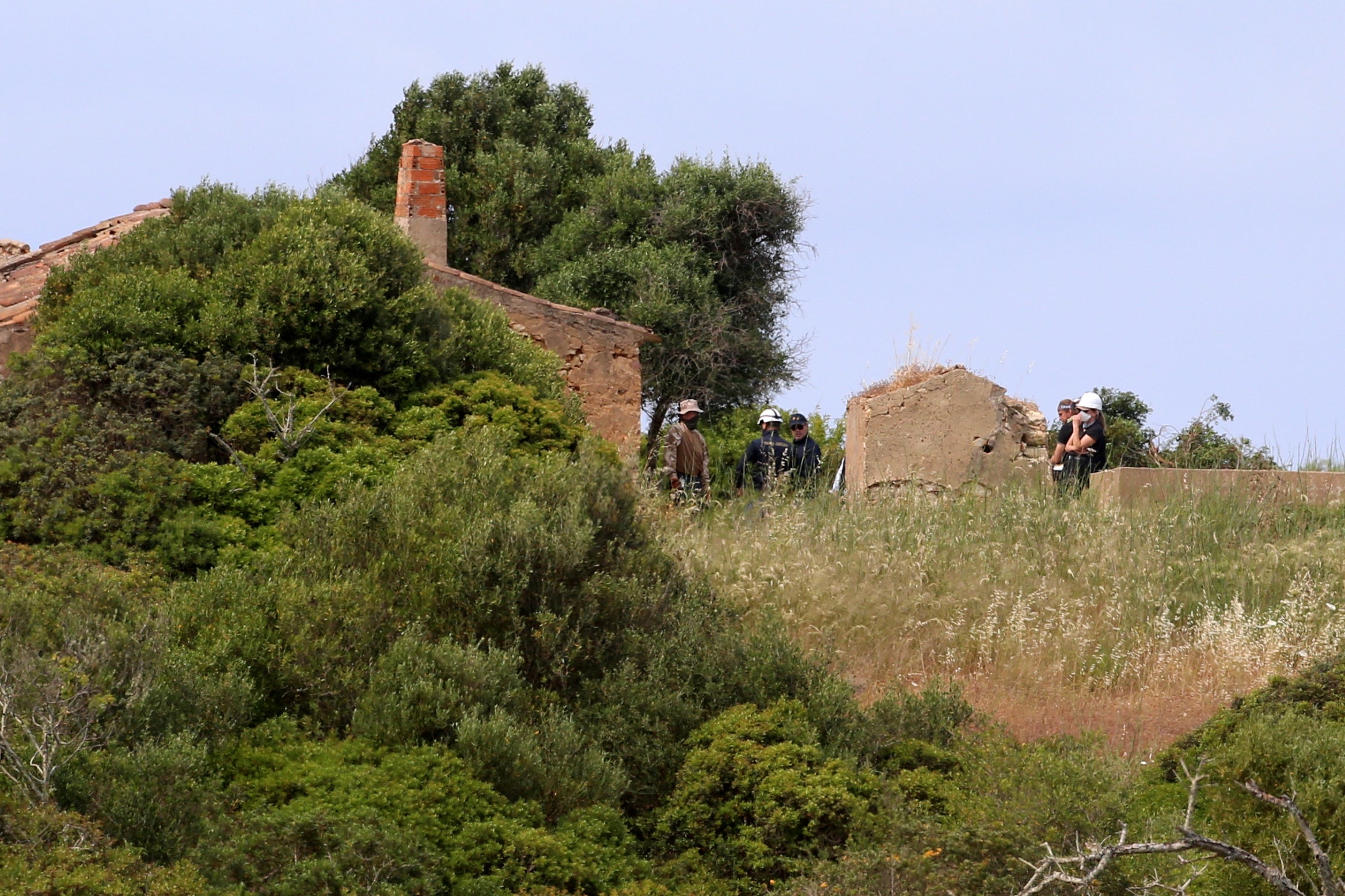 Crews were seen using shovels, pickaxes and chainsaws in the search on Tuesday