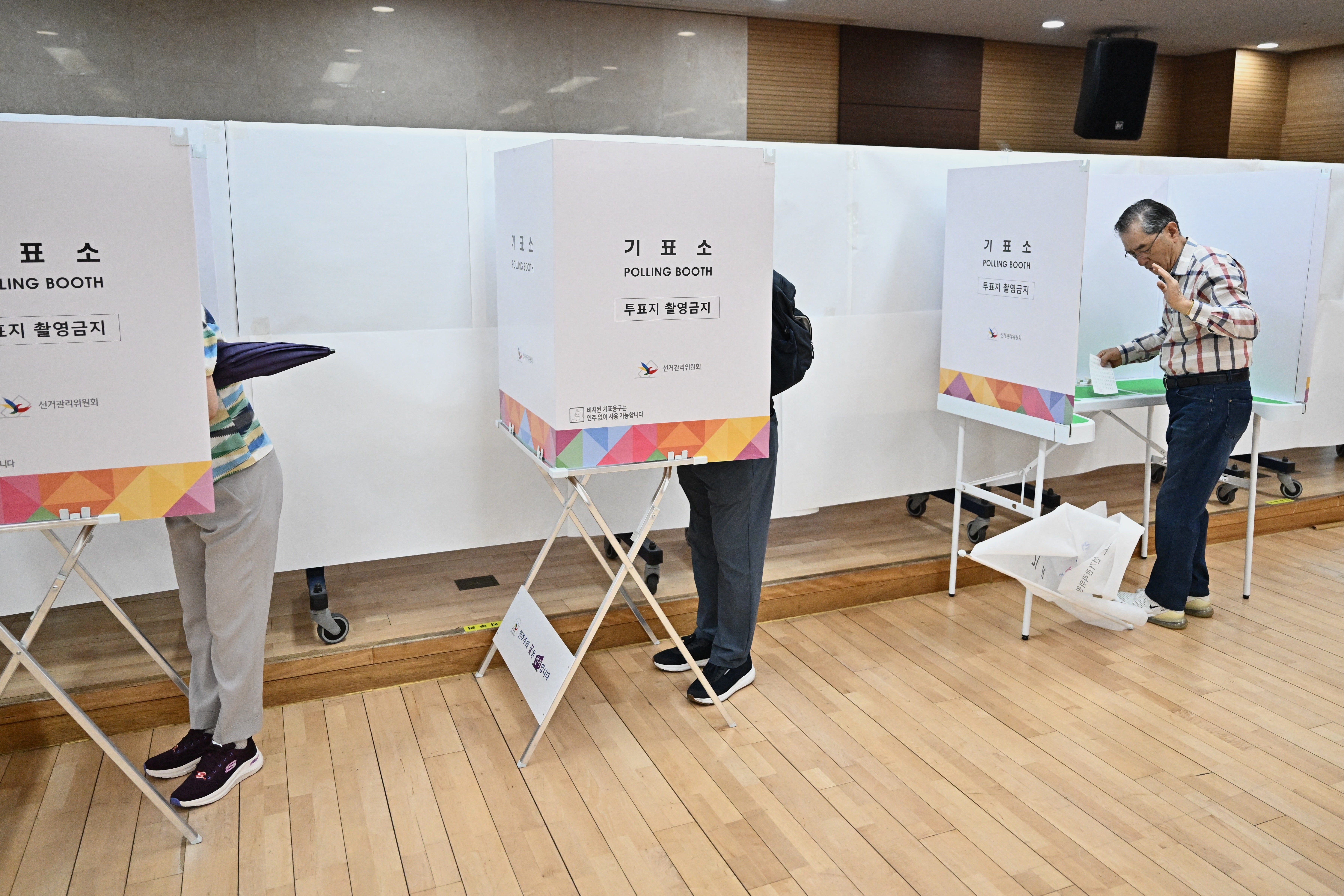 People vote at a polling station during the presidential election in Seoul