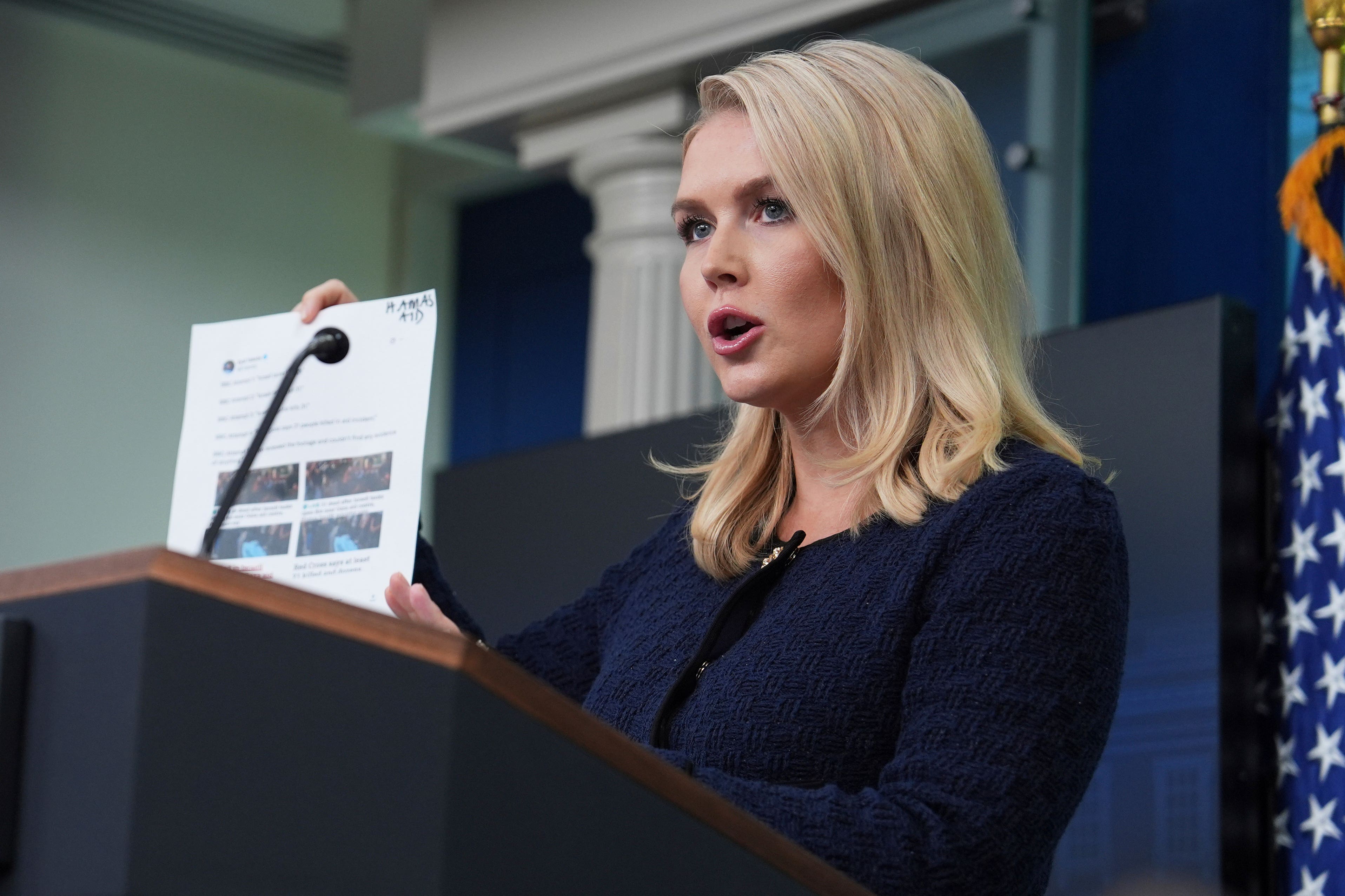 White House press secretary Karoline Leavitt holds up BBC headlines during a briefing at the White House