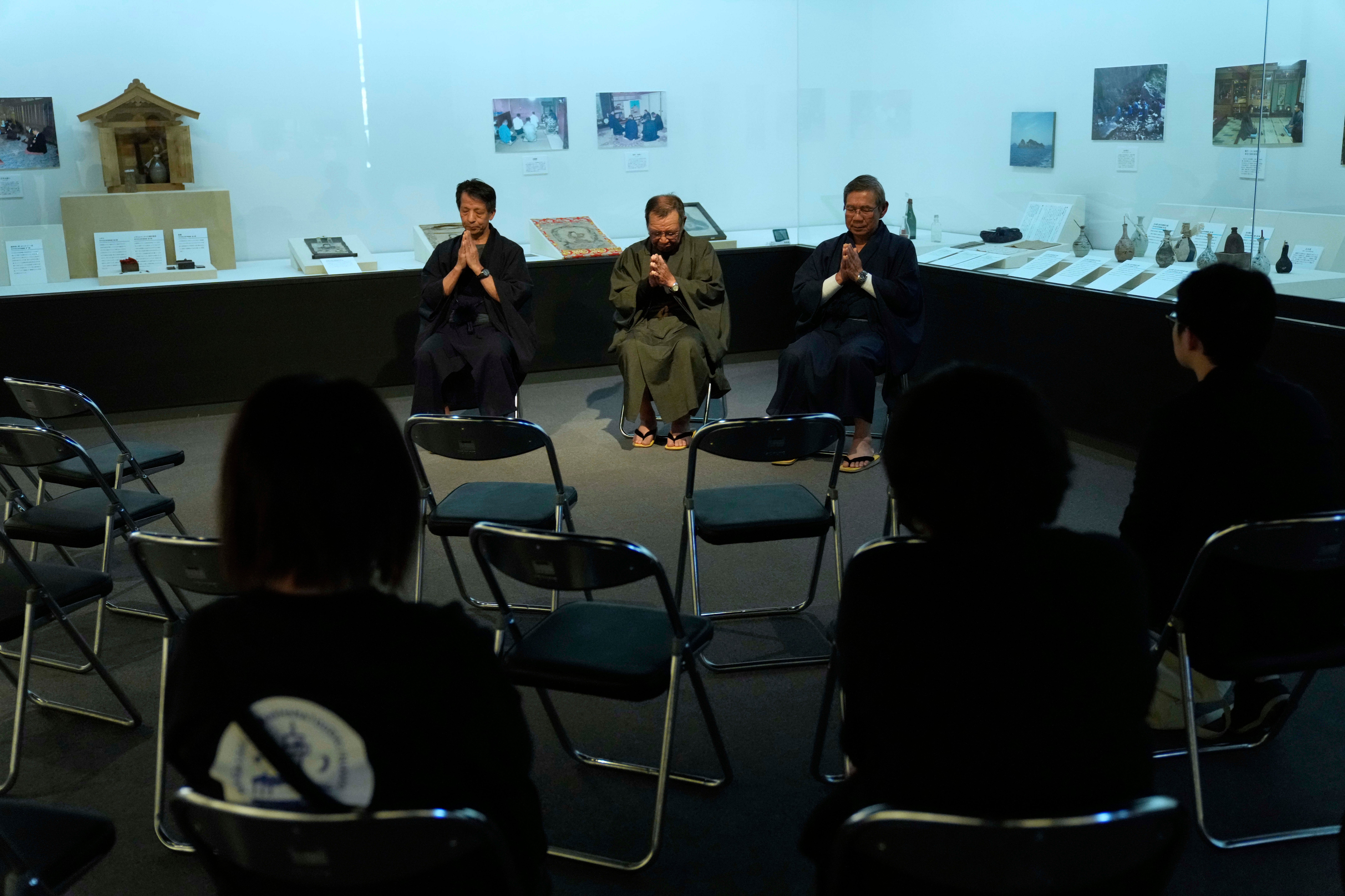 Masatsugu Tanimoto, from left, Yoshitaka Oishi and Yoshinori Yamamoto chant Orasho, recitation of Latin chants, in the Ikitsuki Island Museum “Shima no Yakata”