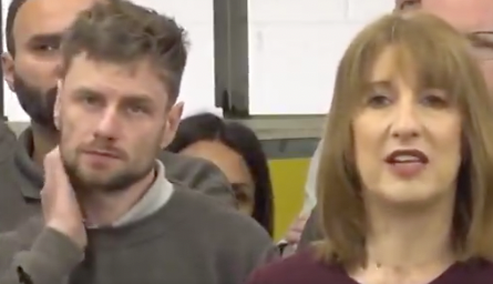 An audience member looks unimpressed by Reeves’s speech