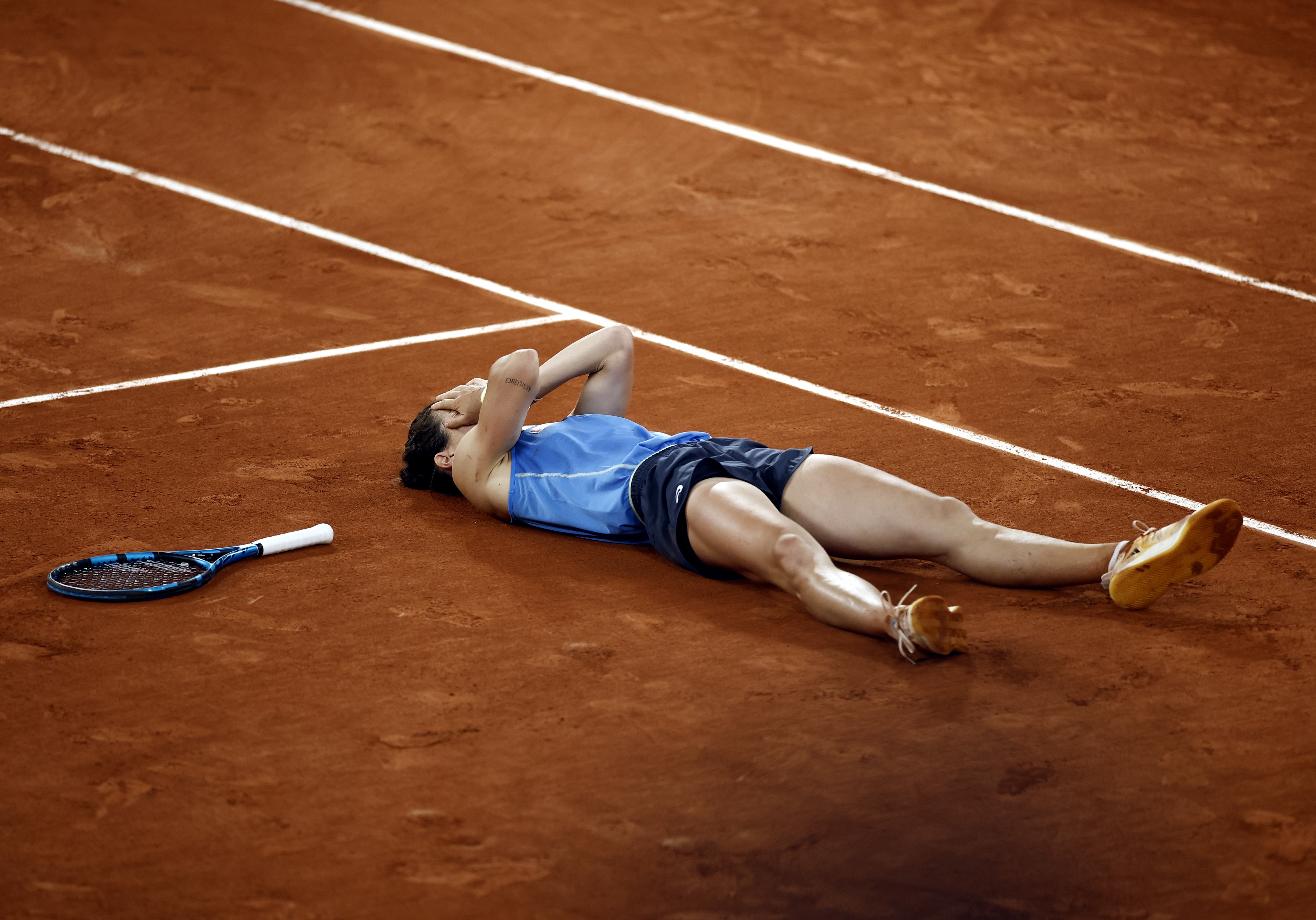 Lois Boisson falls to her back after reaching the semi-finals of the French Open