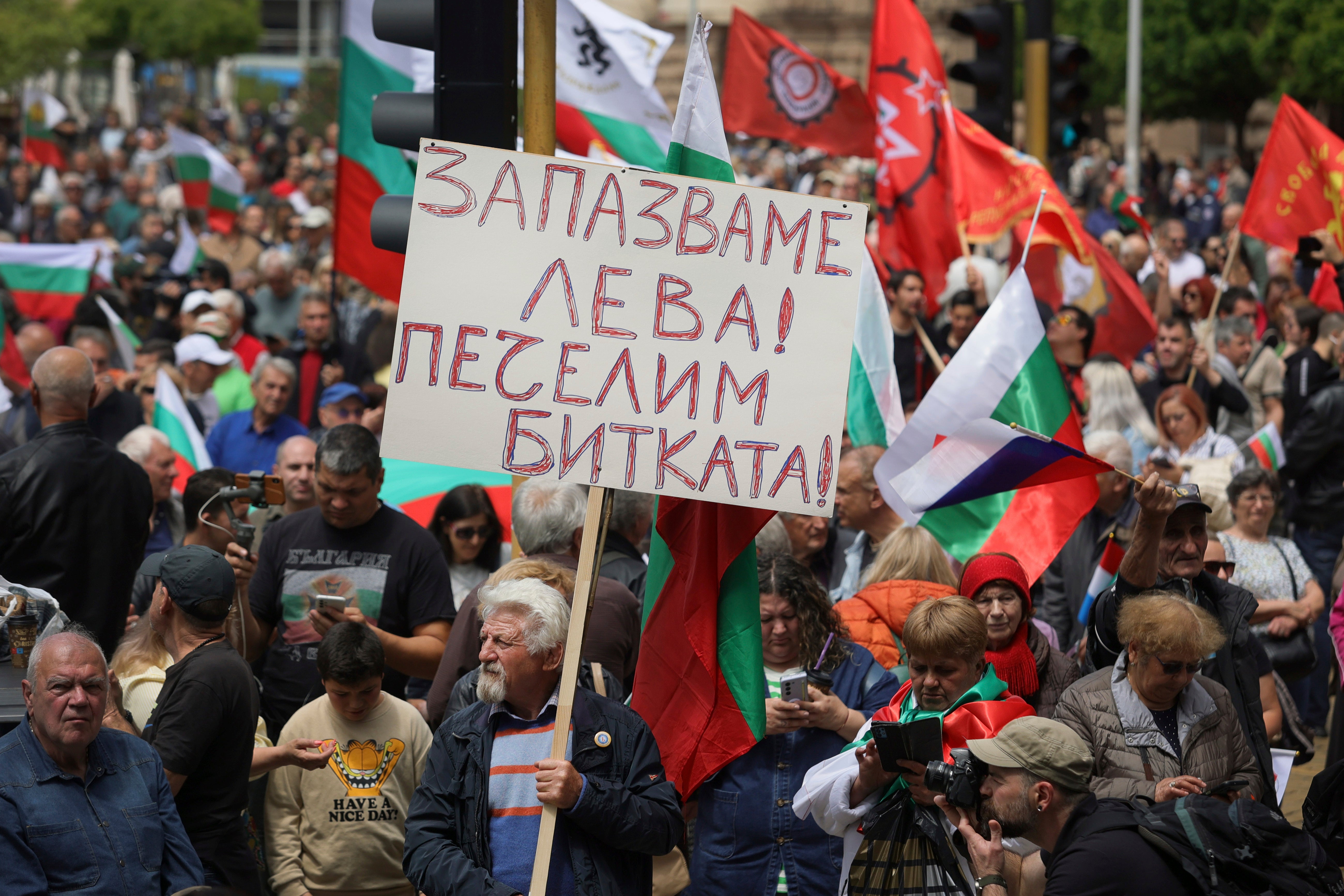 Protester holds a poster reading 'Preserve Bulgarian Lev. Win the battle!' during an anti-Euro protest