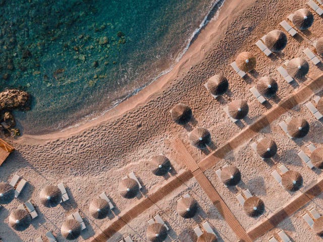 <p>Set against a rugged landscape, head to beach hotels such as Eden Roc for total relaxation by the Aegean Sea</p>