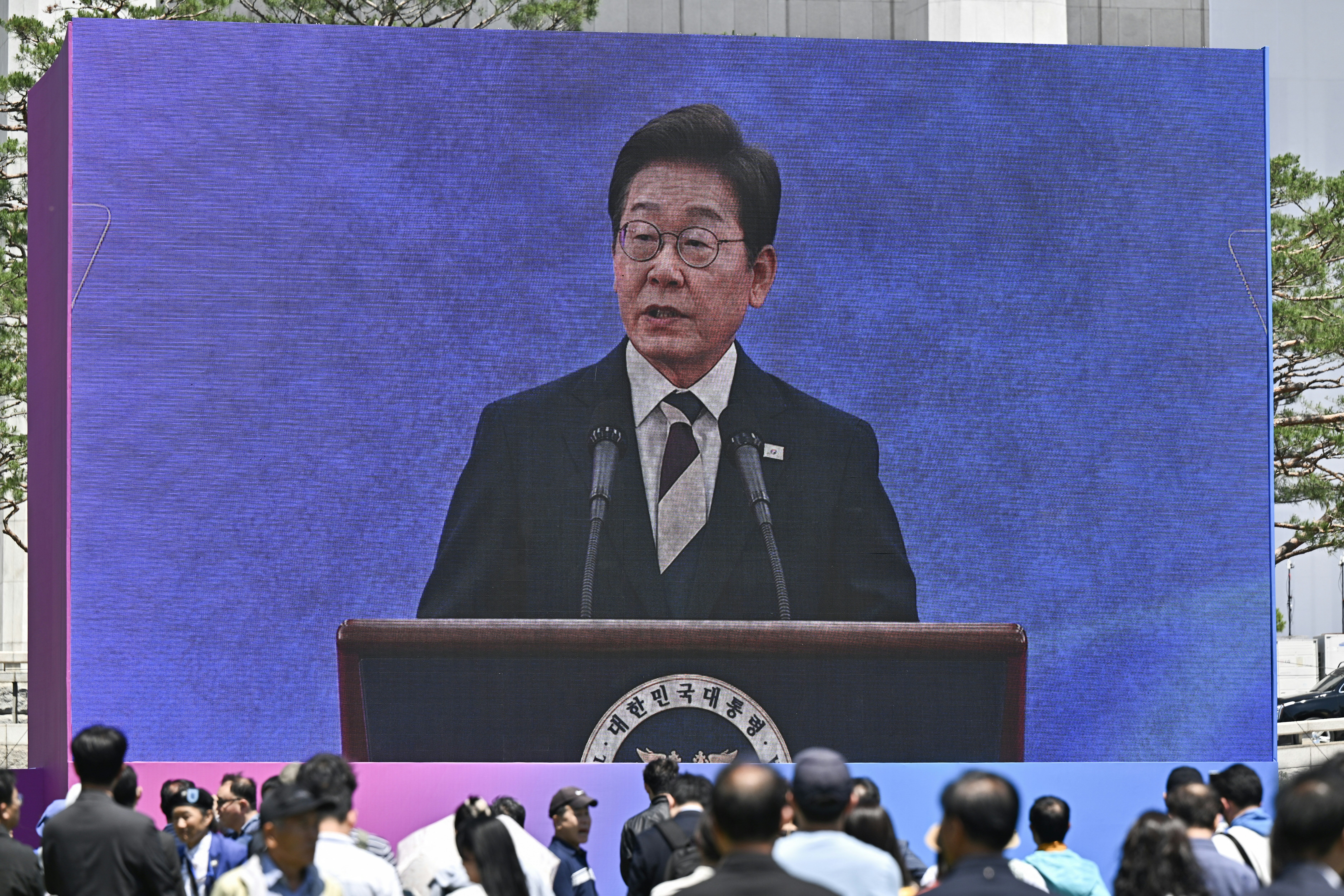 People watch the inauguration ceremony of South Korea's president Lee Jae Myung outside the National Assembly in Seoul on 4 June 2025