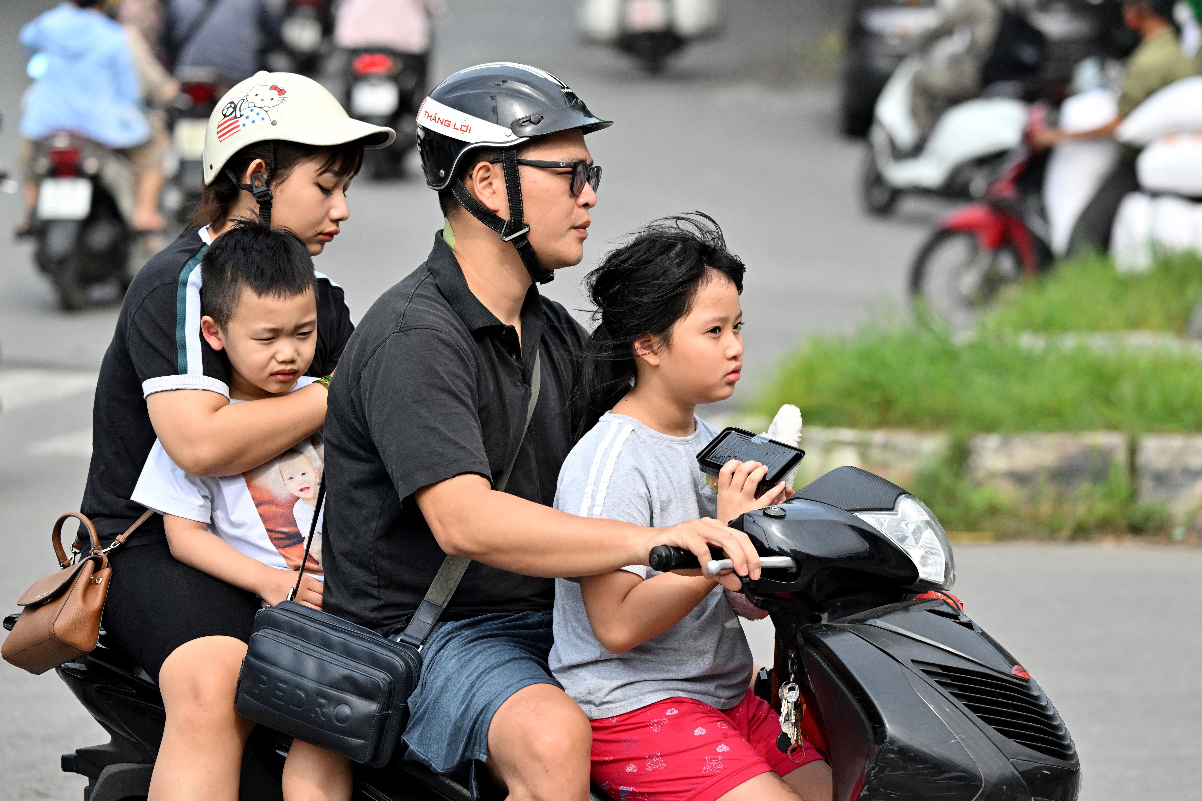 A family rides a motorcycle in Hanoi on 4 June 2025