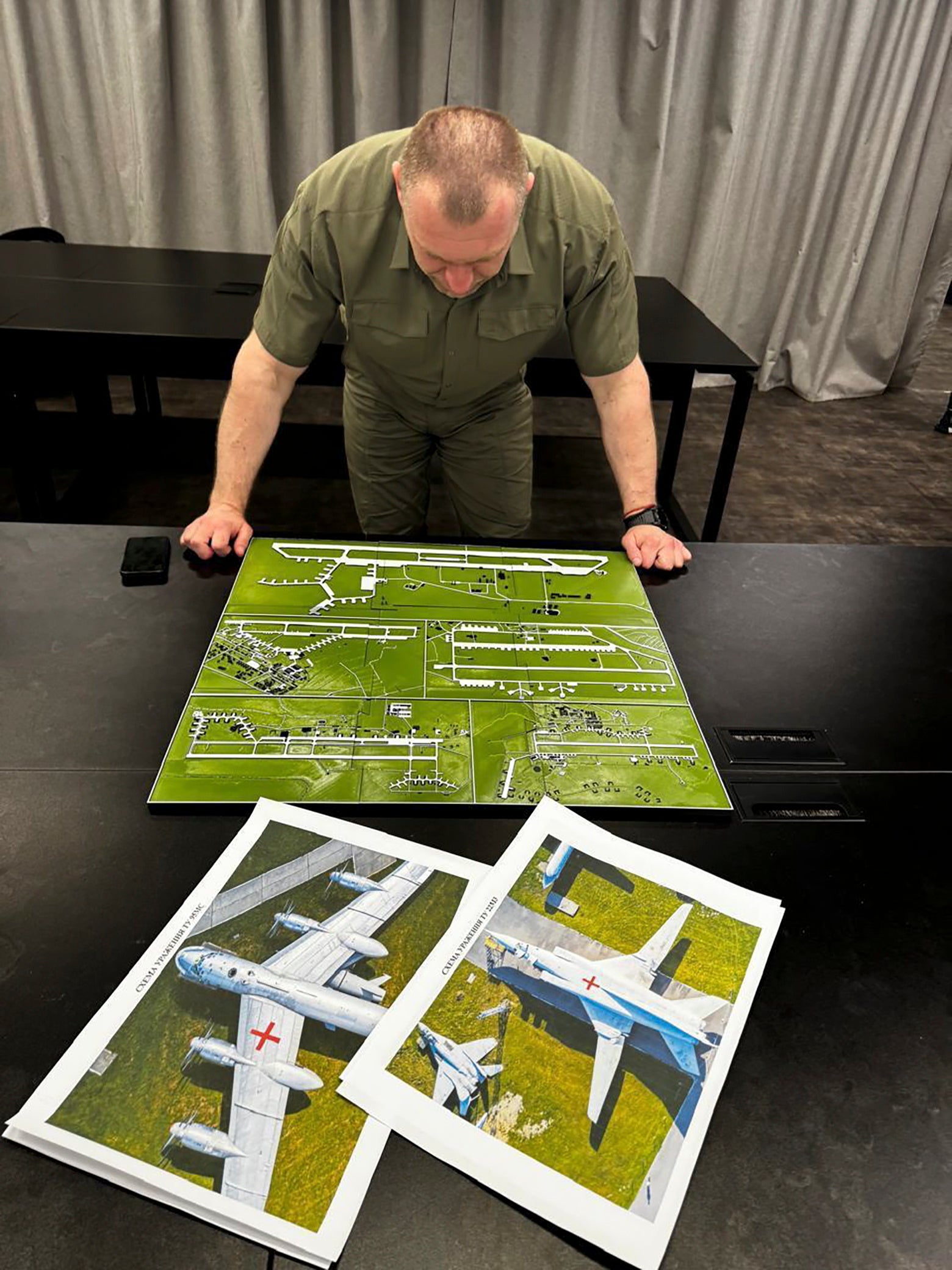 Head of Ukraine’s security service Vasyl Malyuk studying a photo of a map of Russia's strategic aviation location