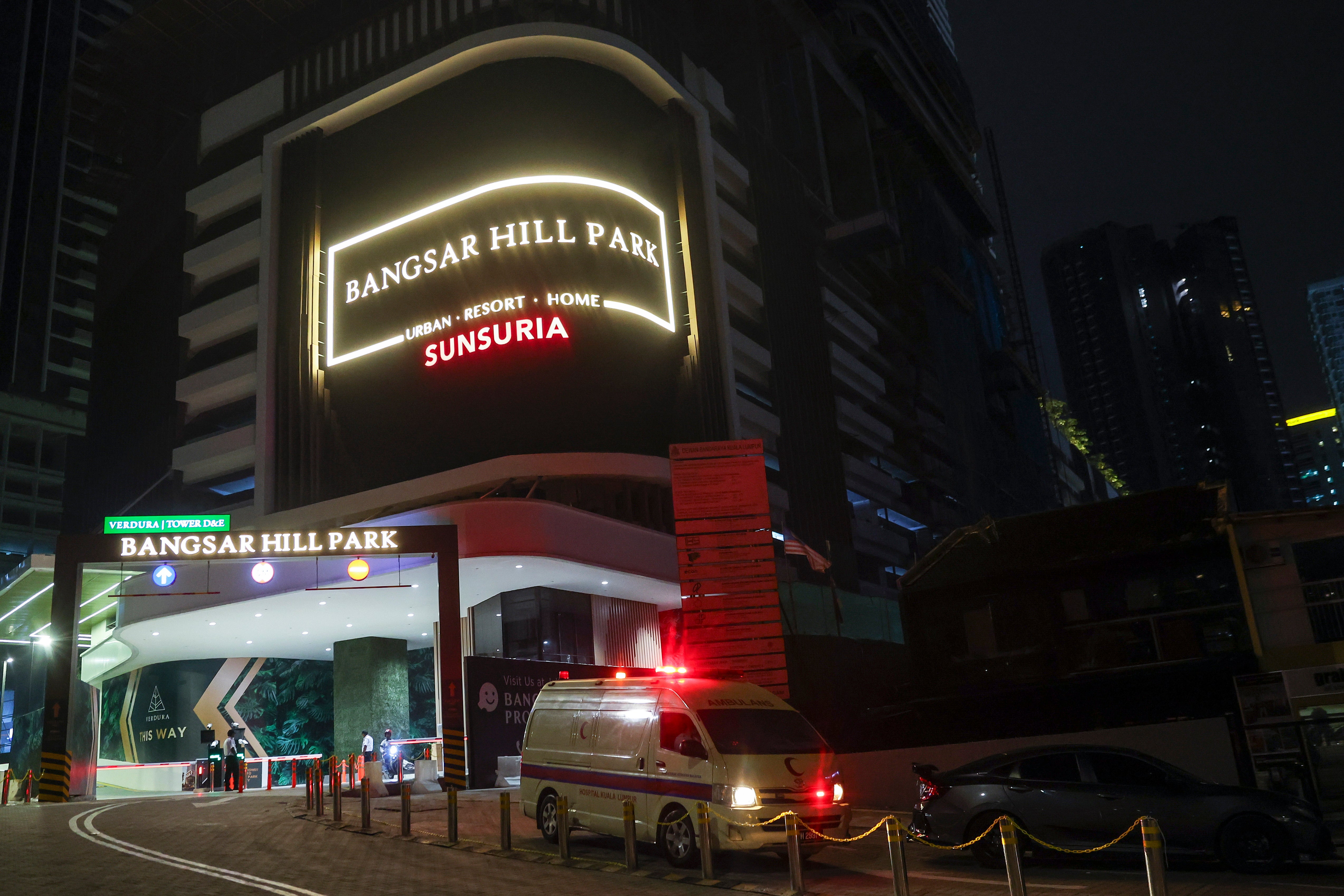 An ambulance leaves a construction site where Mr Doyle's body was found