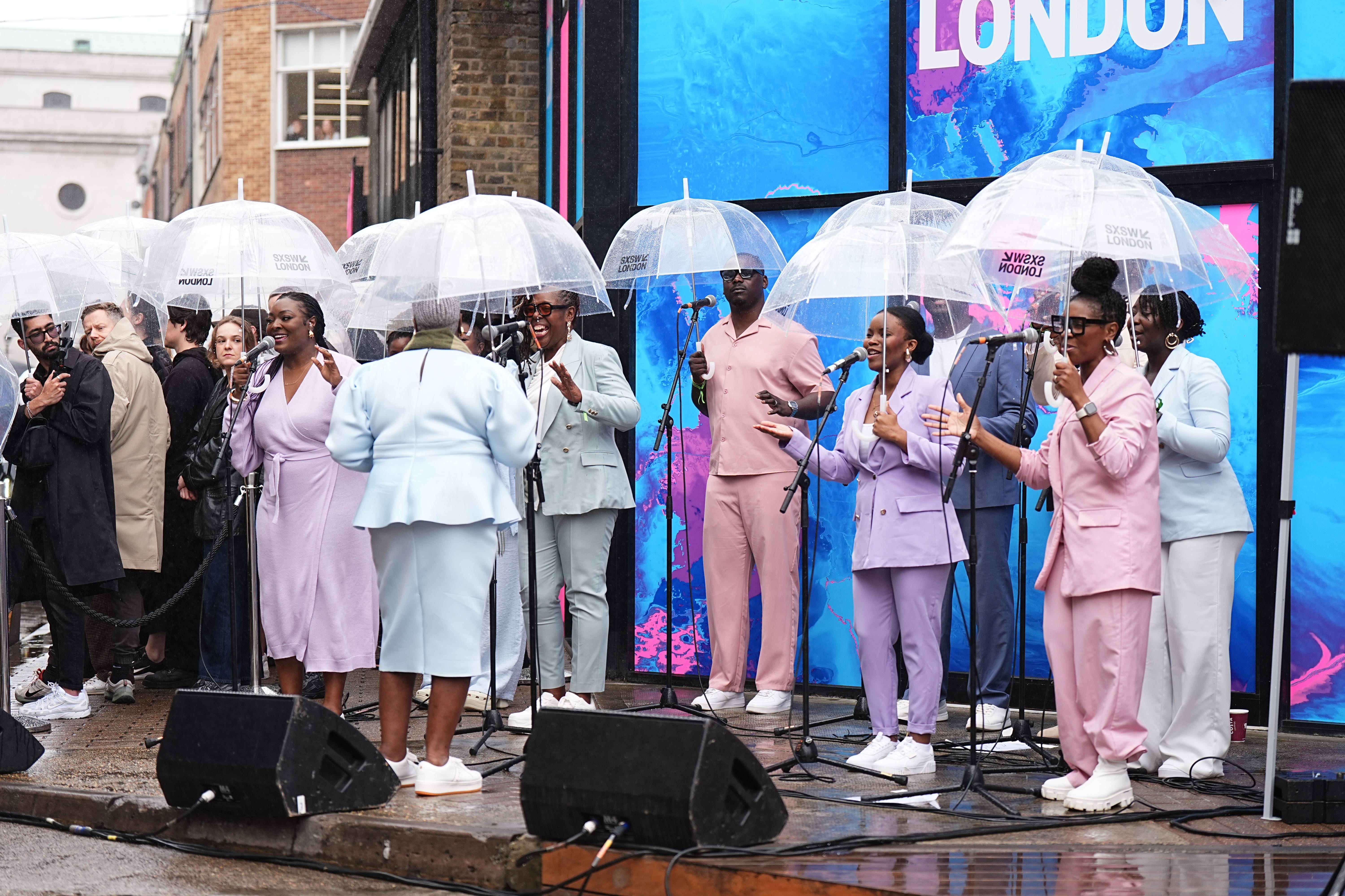 Members of the Kingdom Choir sing as Charles arrives at Old Spitalfields Market in east London (Aaron Chown/PA)