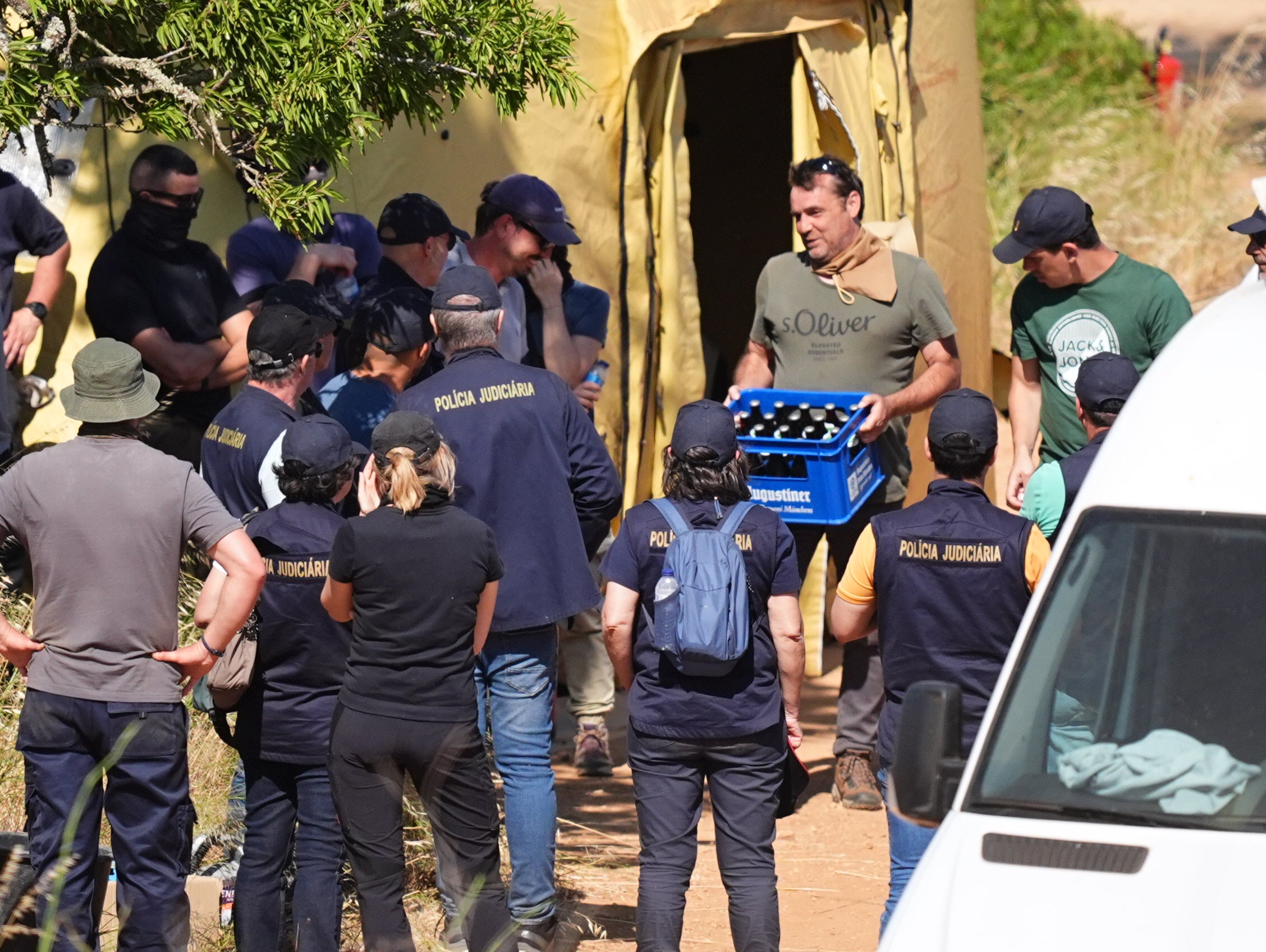 A crate of drink is produced by members of the search teams as the search appeared to come to an end on Thursday