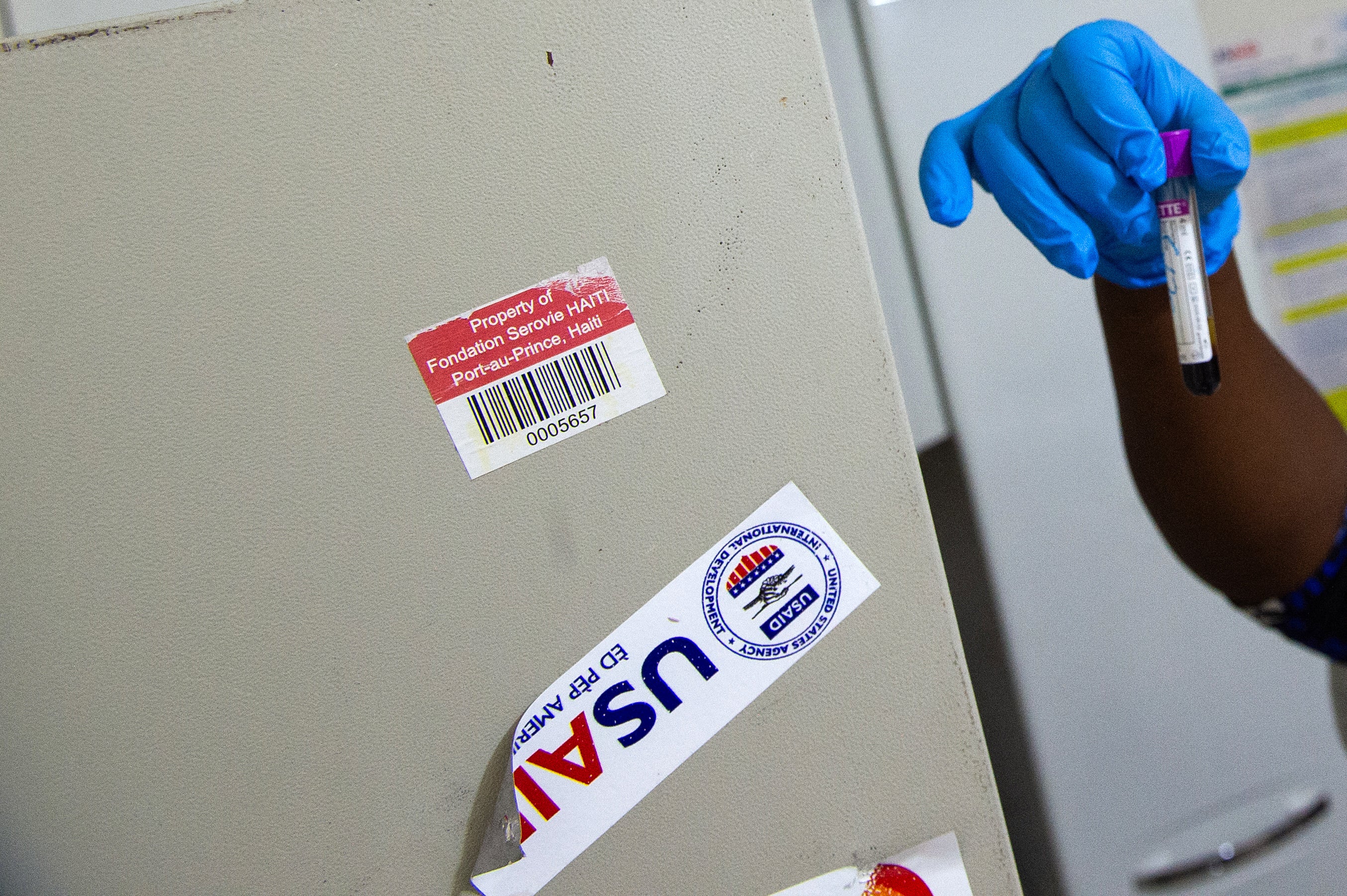 A nurse performs an HIV test in Haiti. Several HIV prevention drugs and contraceptives purchased by USAID are set to be destroyed if they're not sold, according to a new report