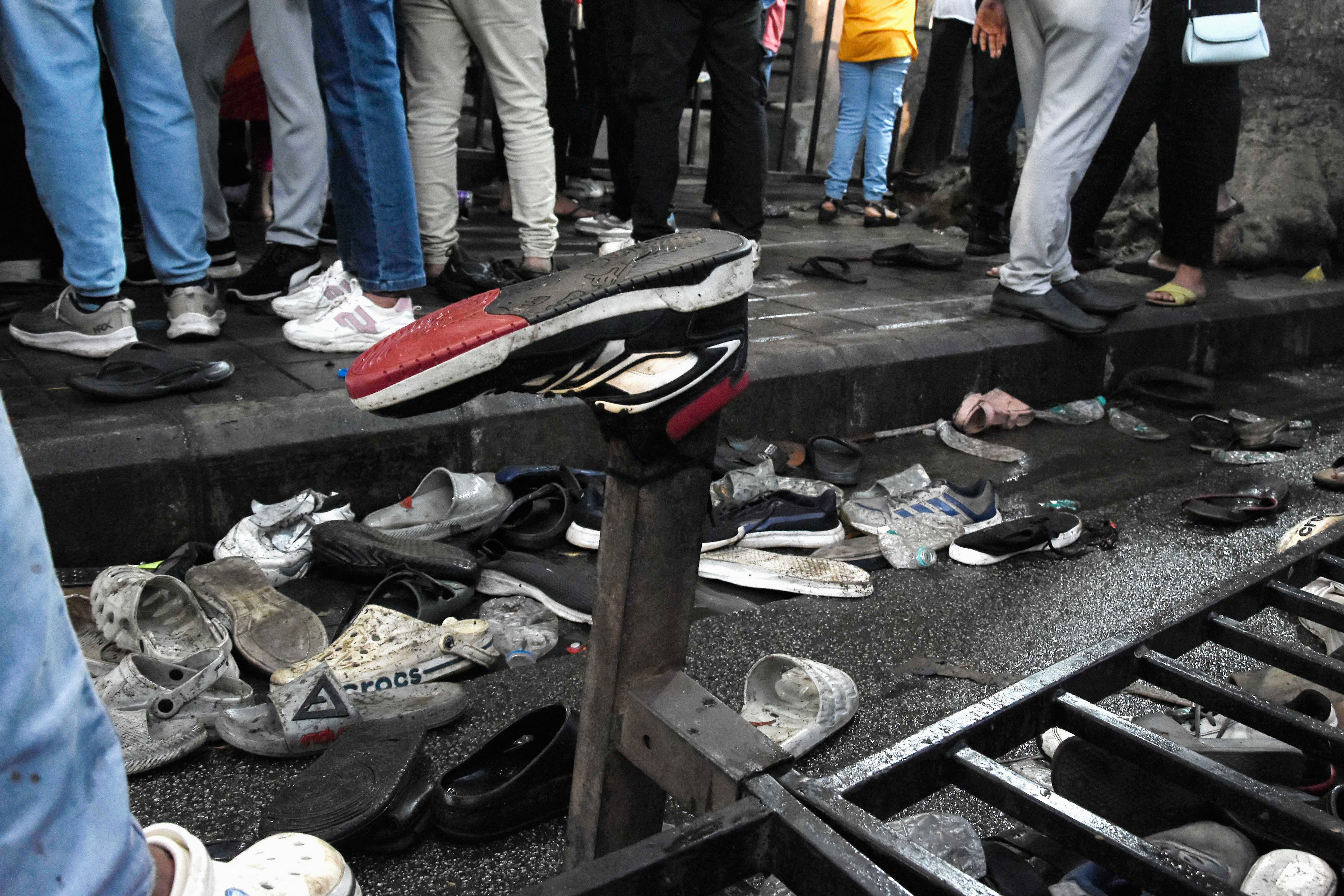 Shoes of stampede victims lie abandoned near the M. Chinnaswamy Stadium in Bengaluru