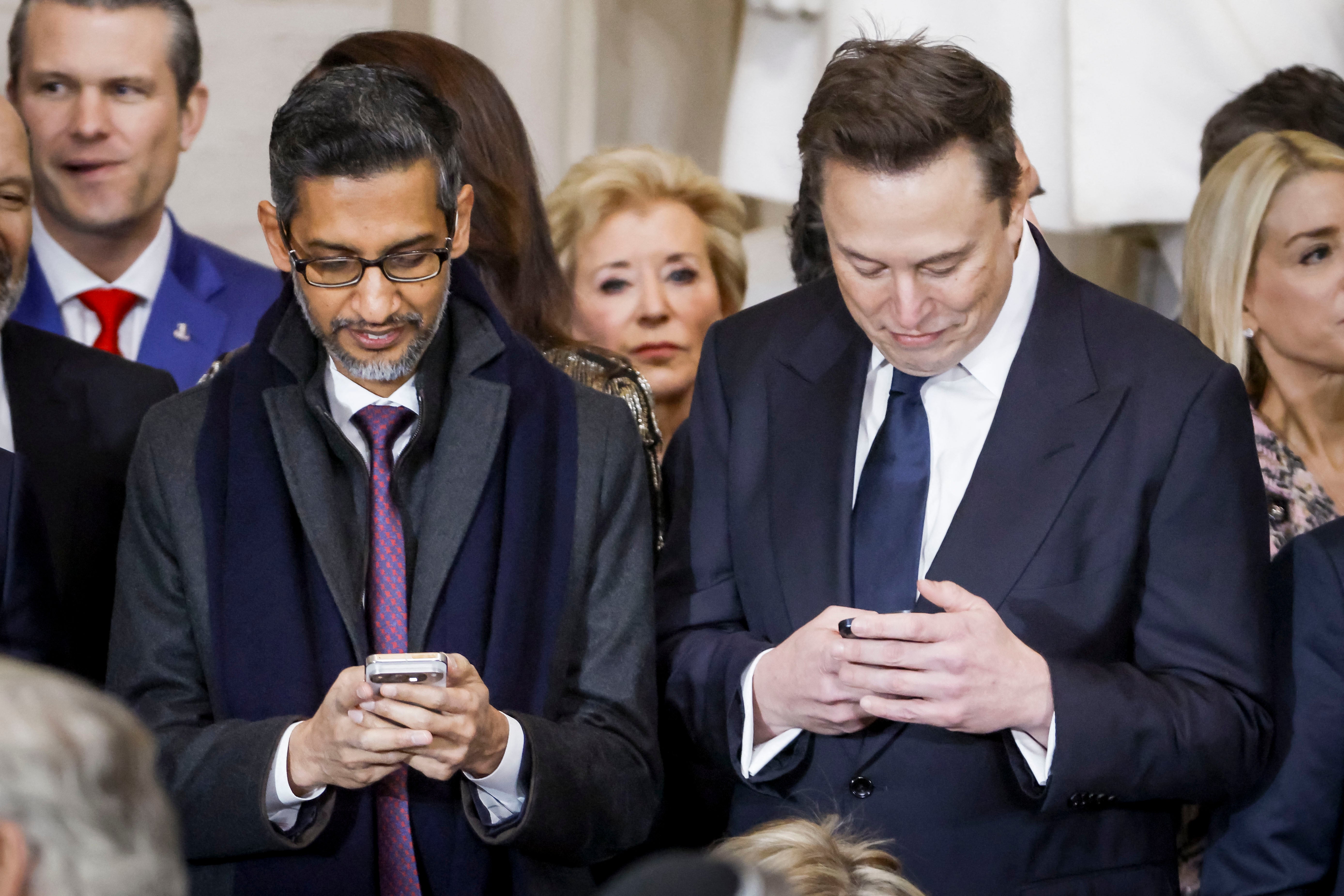 Elon Musk (R), besides Alphabet’s CEO Sundar Pichai, at Donald Trump’s inauguration in Janaury