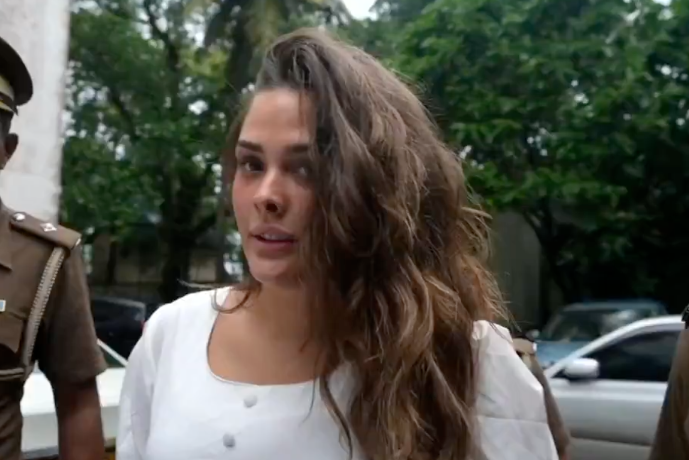 Charlotte May Lee, seen for the first time since her arrest, arrives at a court hearing in Colombo with her hands cuffed behind her