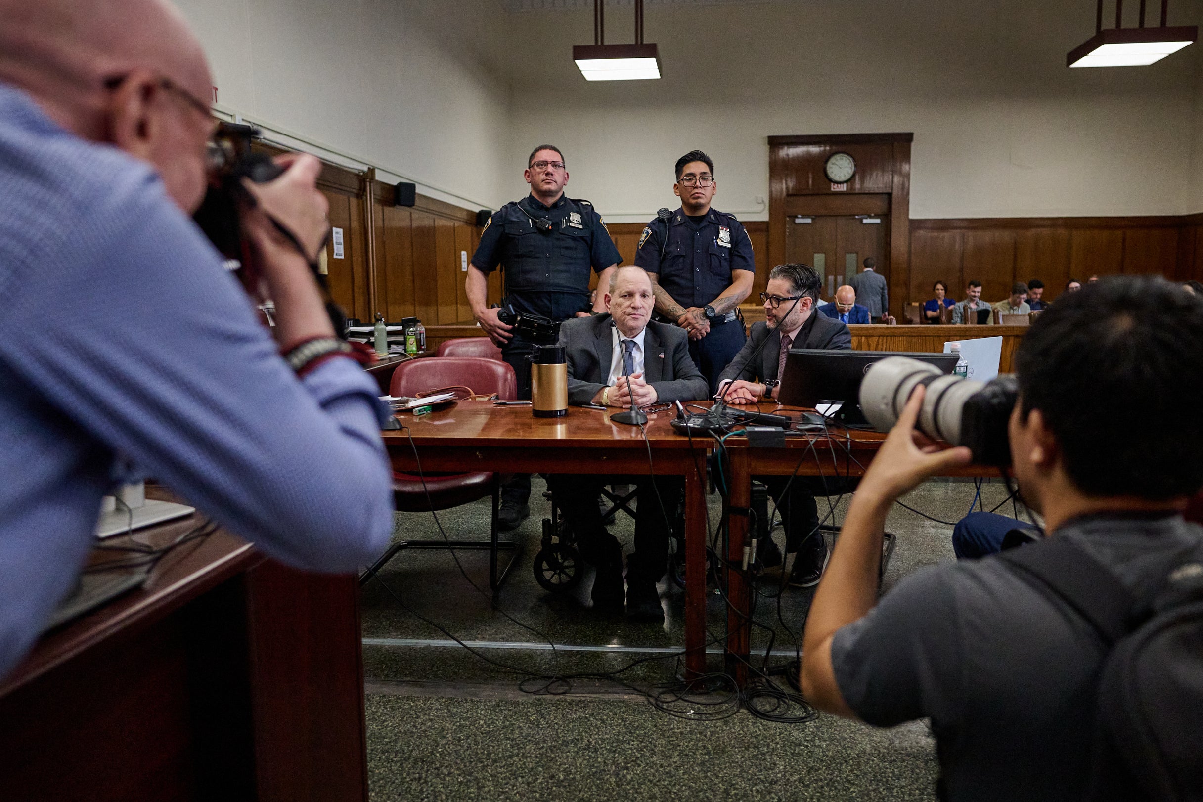 Journalists take pictures as former Hollywood film producer Harvey Weinstein appears in Manhattan criminal court during his rape and sexual assault retrial in New York on June 6