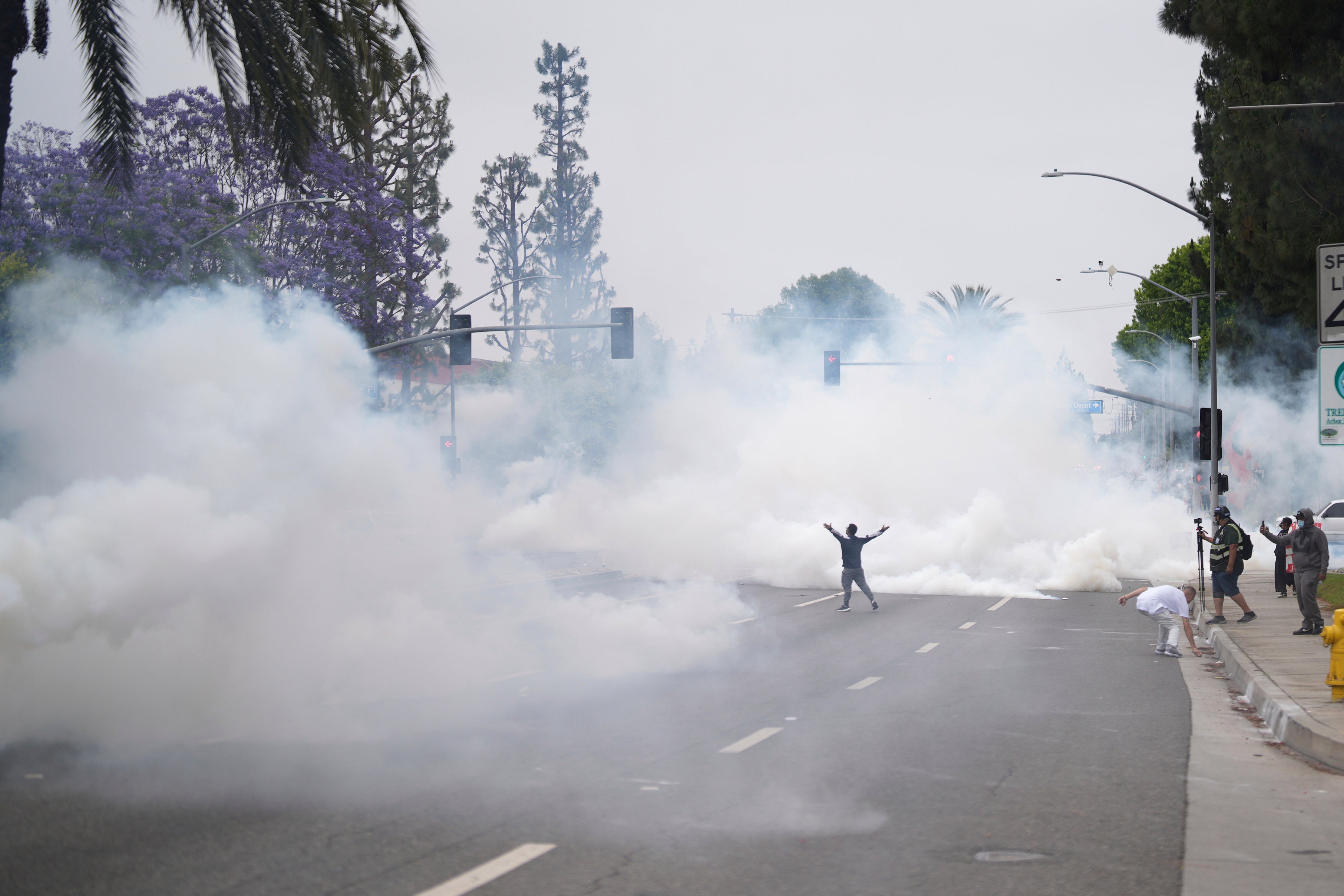 Smoke fills the street as protesters confront law enforcement