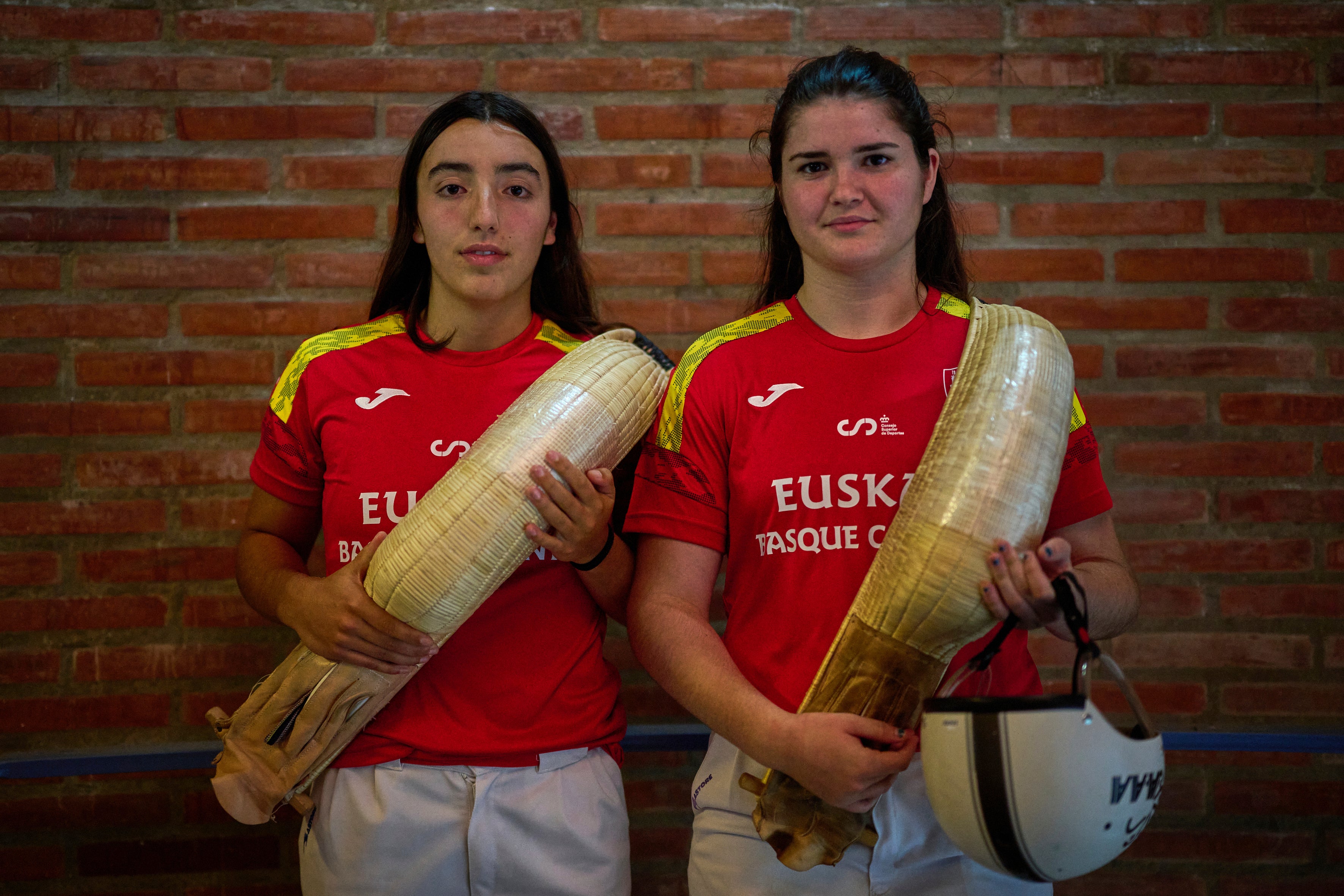 Arai Lejardi, left, and Erika Mugartegui, members of the Spanish national team, pose for a photo ahead of the Nations League match between the Euskadi national team and the Spanish national team at the Jai Alai fronton in Guernica-Luno, northern Spain, Friday, June 6, 2025. (AP Photo/Miguel Oses)
