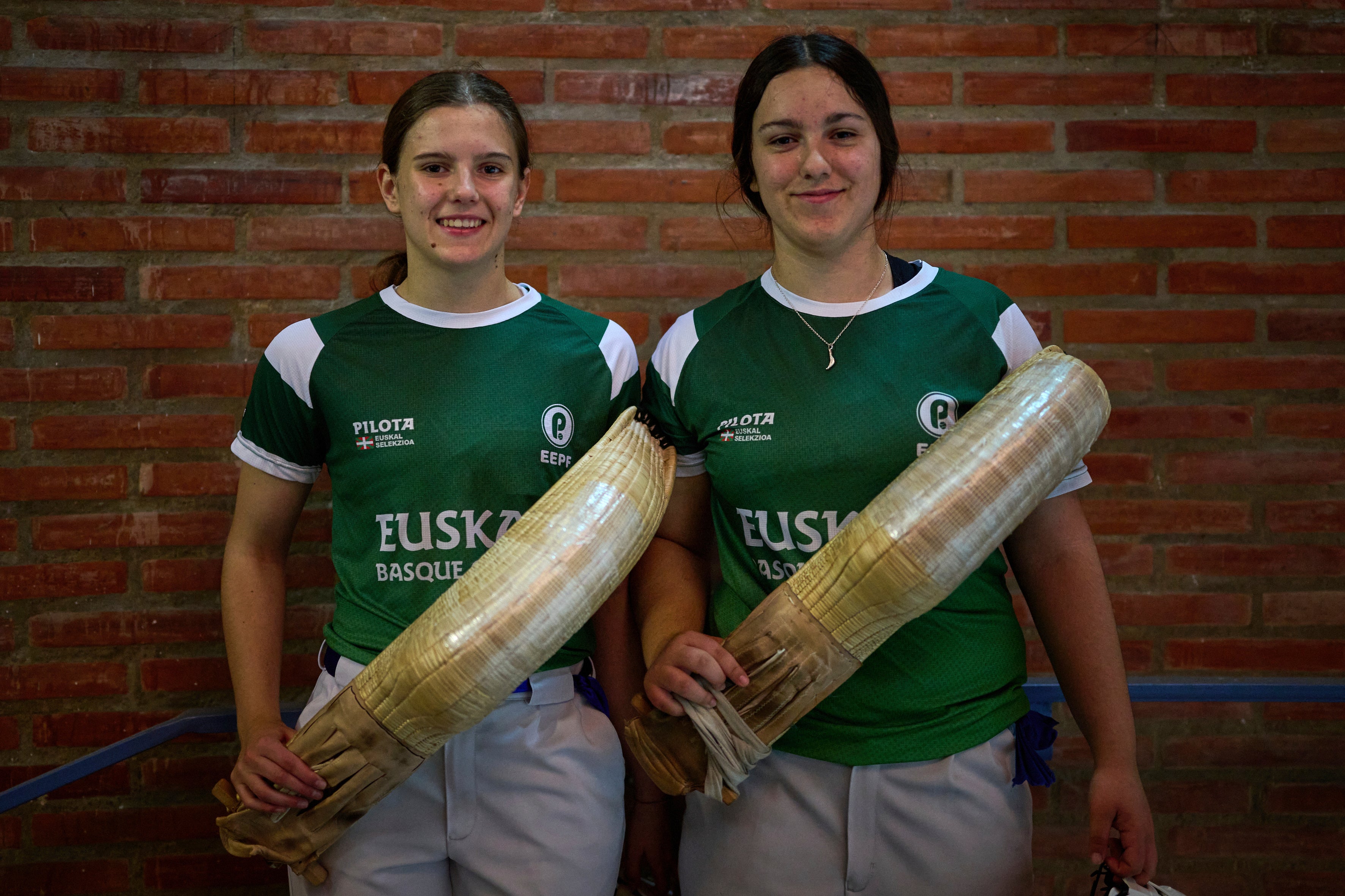 Elaia Gogenola, left, and Maia Goikoetxea, members of the Euskadi national team, pose for a photo ahead of the Nations League match between the Euskadi national team and the Spanish national team at the Jai Alai fronton in Guernica-Luno, northern Spain, Friday, June 6, 2025. (AP Photo/Miguel Oses)