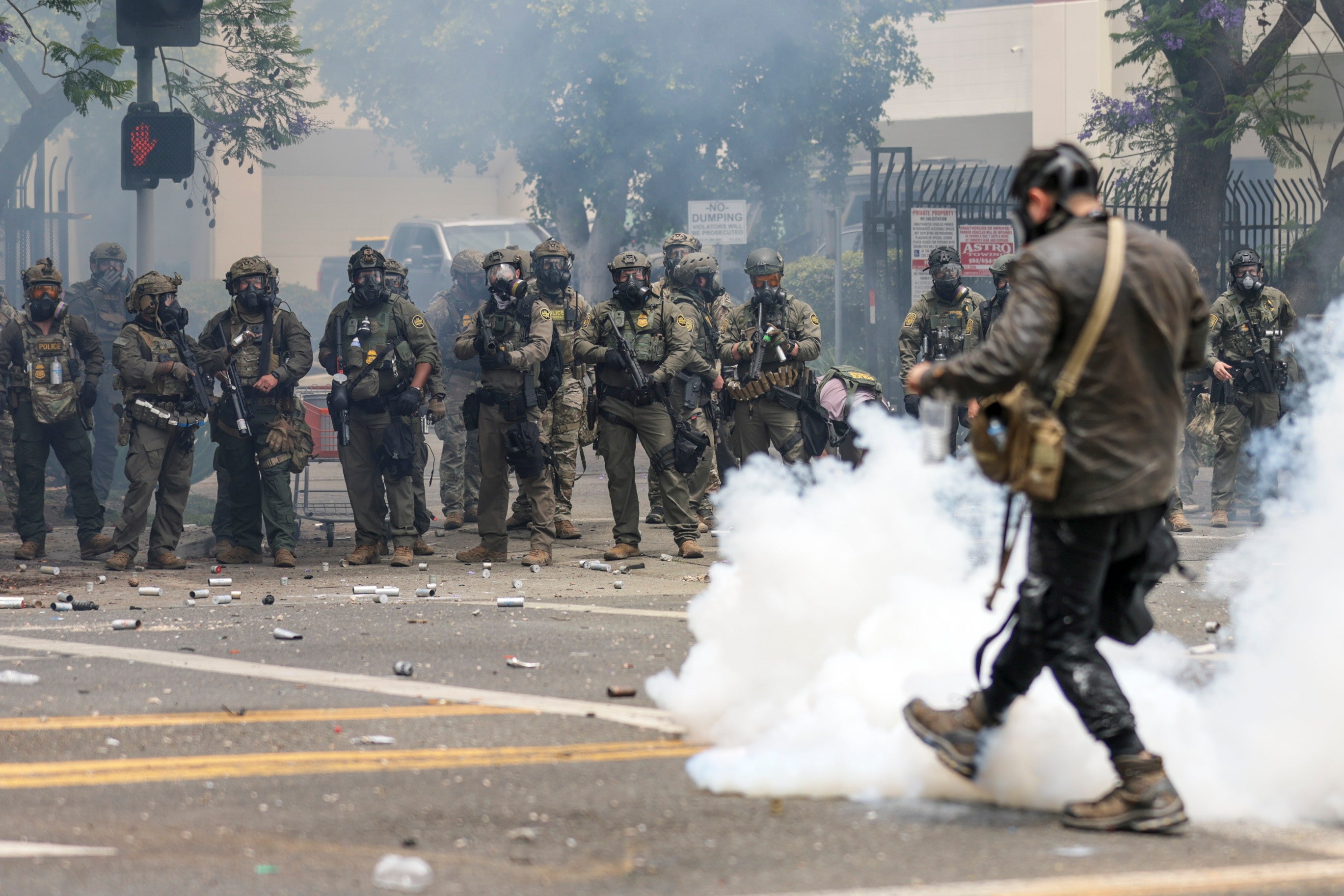 Federal agents fire flash-bang smoke grenades at protestors near a Home Depot after a raid was conducted by Immigration and Customs Enforcement (ICE) in Paramount, California, USA, 07 June 2025