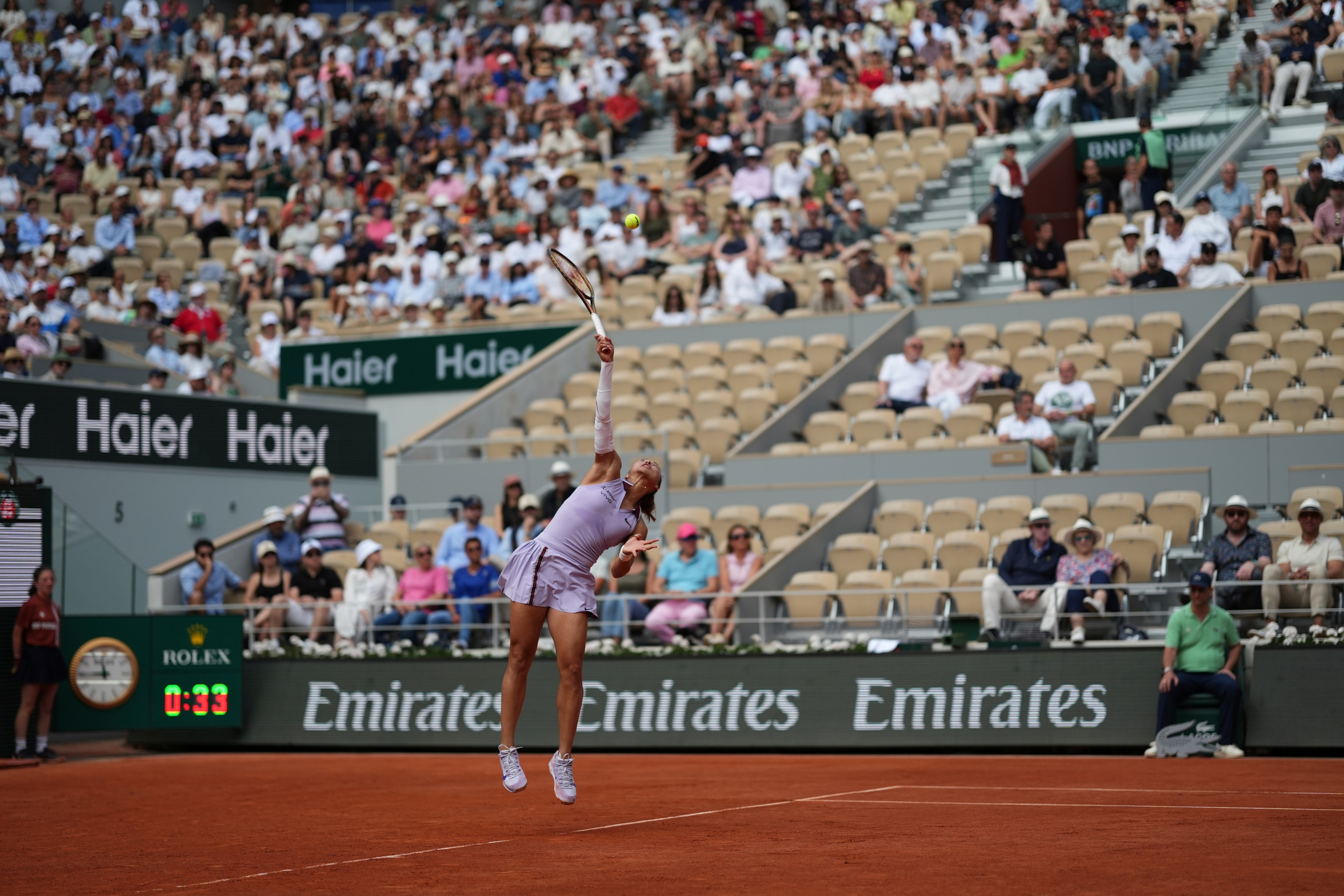 Qinwen Zheng serves against Aryna Sabalenka (Aurelien Morissard/AP)
