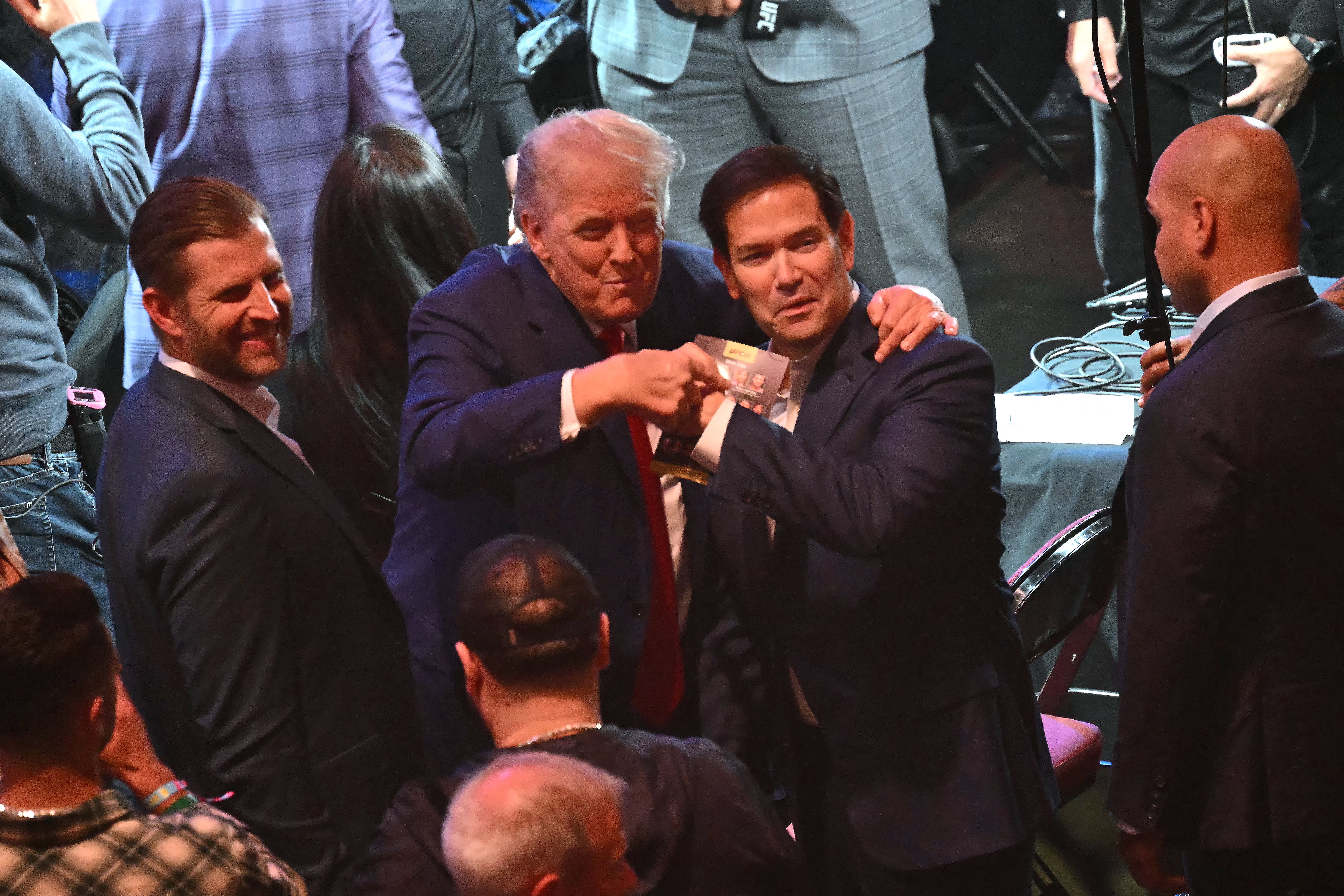Trump laughs with his son Eric, left, and Secretary of State Marco Rubio, center
