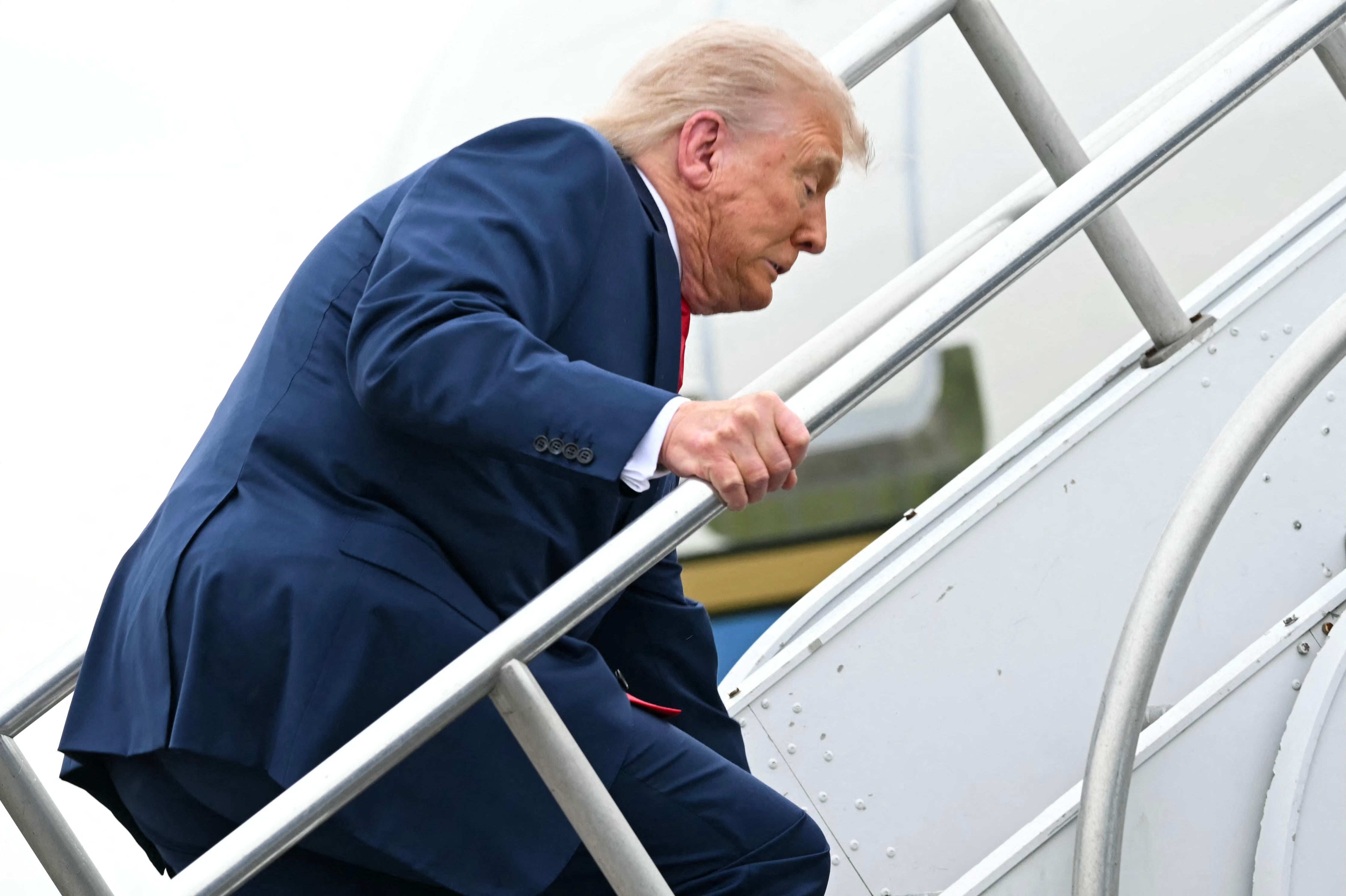 Trump stumbled as he made his way up the stairs of Air Force One on Sunday