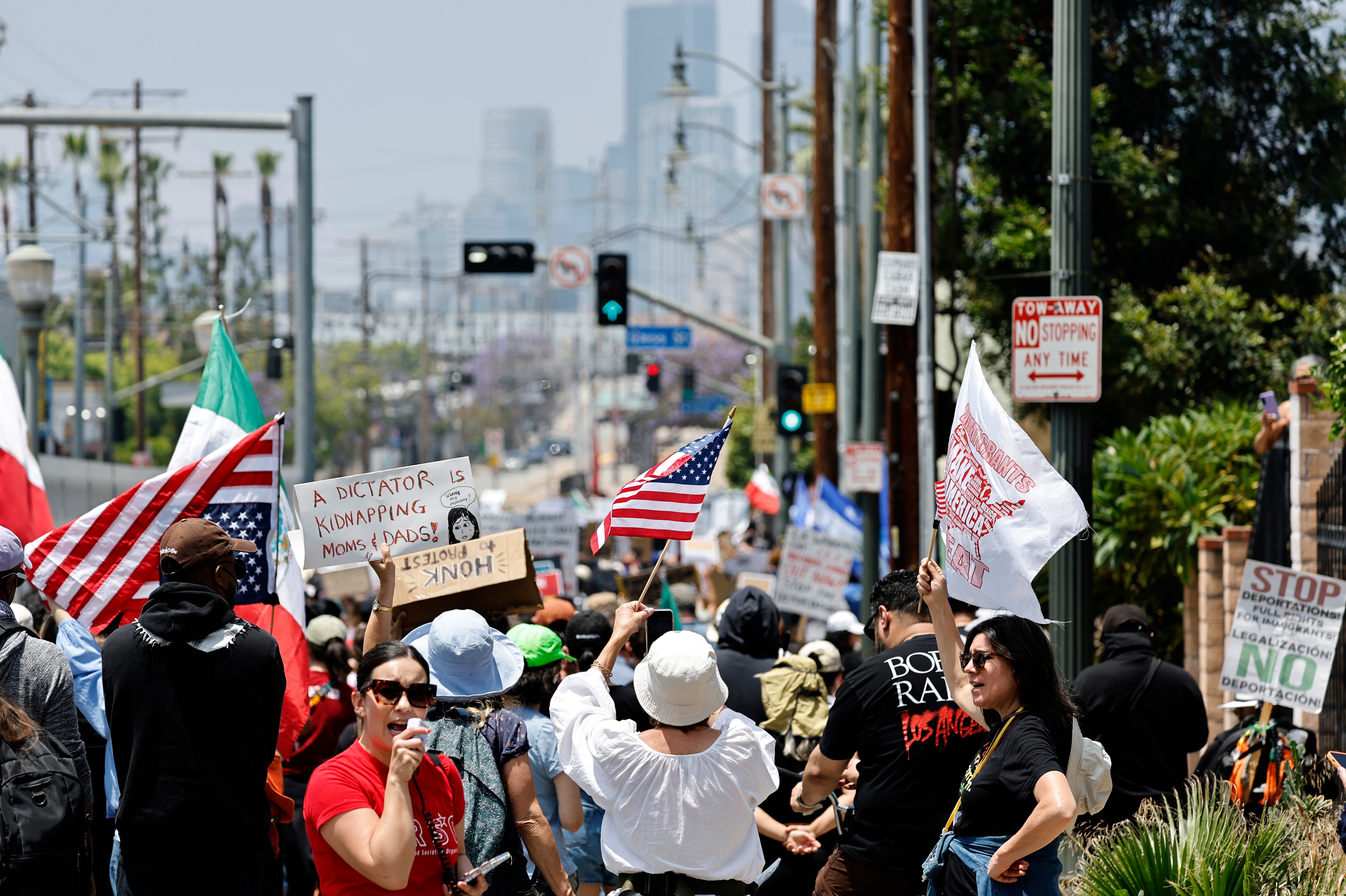 Protestors against immigration raids march toward downtown Los Angeles on June 08, 2025 in Los Angeles, California. Trump told reporters that if protesters spat at law enforcement they would get ‘hit very hard’