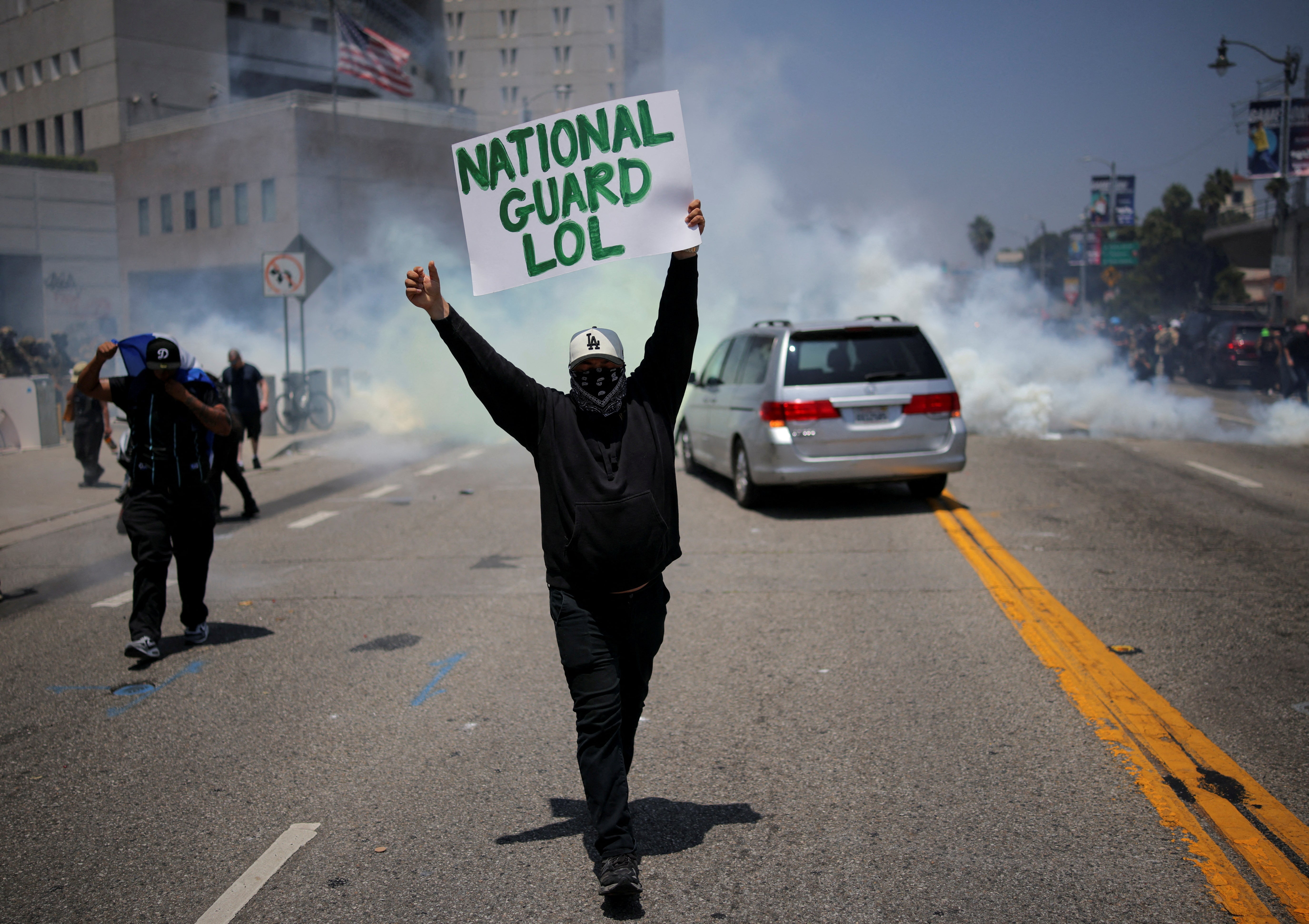 A demonstrator holds a placard during a protest against federal immigration sweeps in downtown Los Angeles, California. On Sunday Donald Trump vowed to ‘liberate’ the city from ‘the Migrant Invasion’