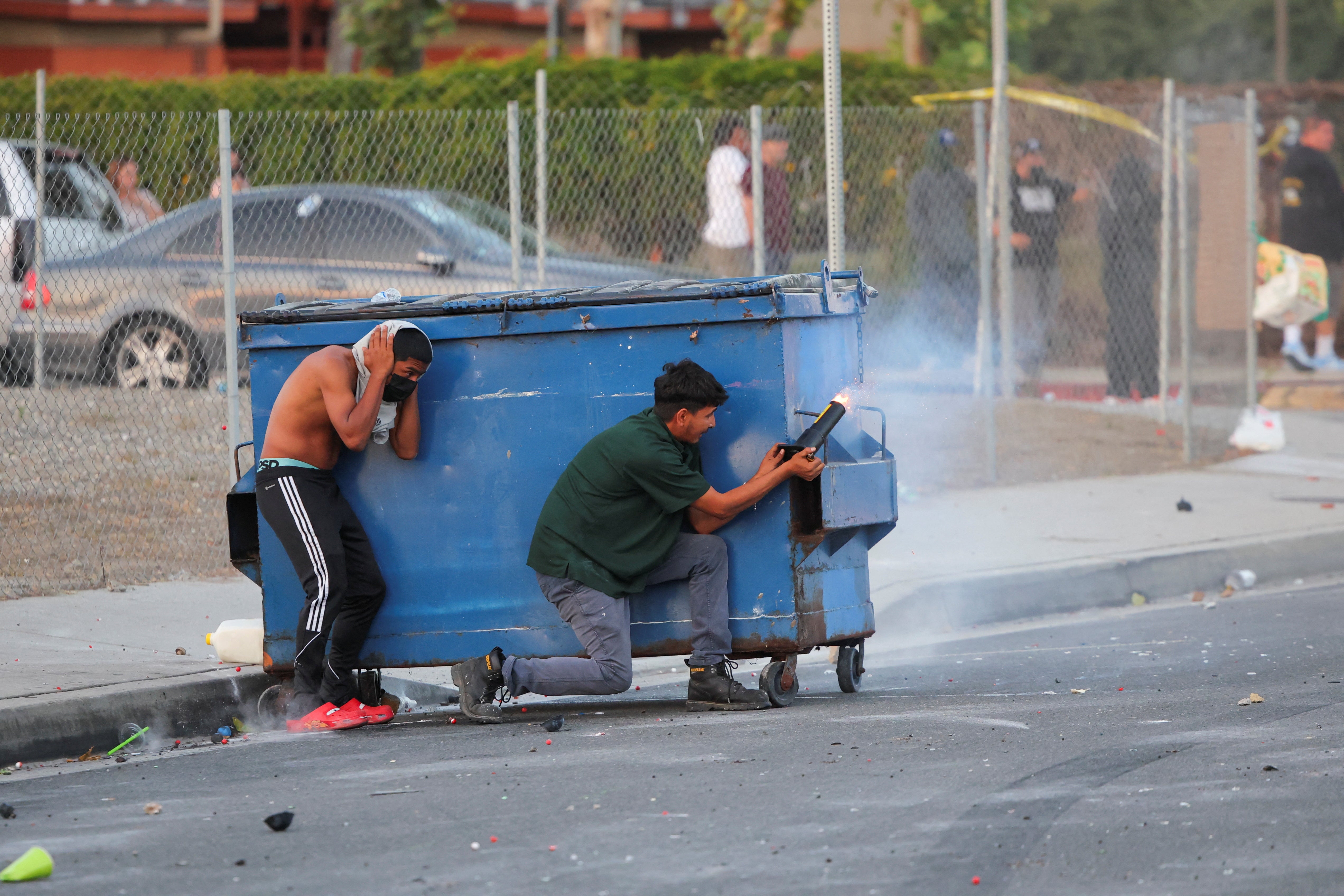 A protesters fires a firework during a standoff between police and protesters following multiple detentions by Immigration and Customs Enforcement (ICE), in the Los Angeles County city of Paramount, California, U.S., June 7