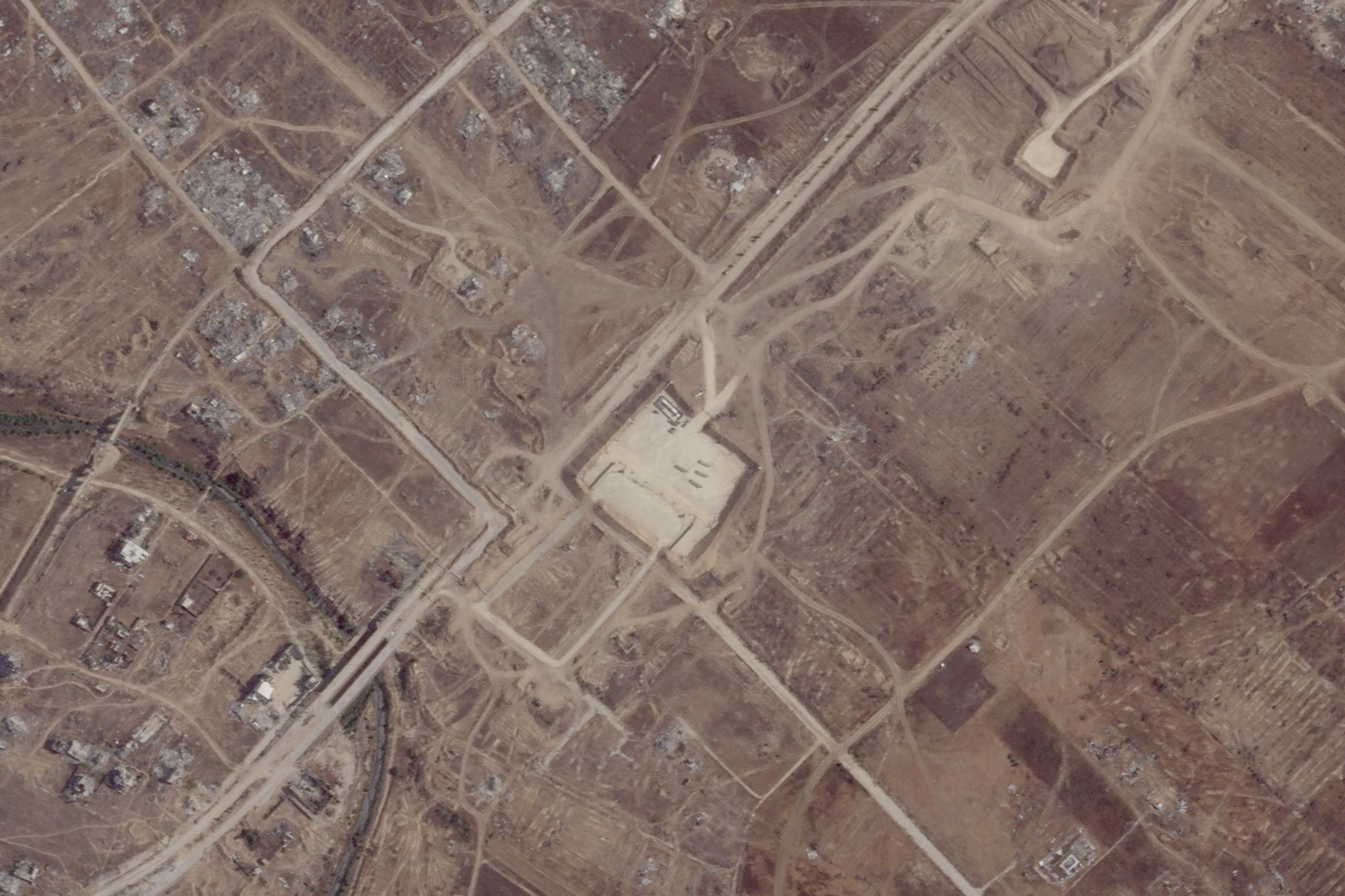 A satellite view shows an aid distribution site